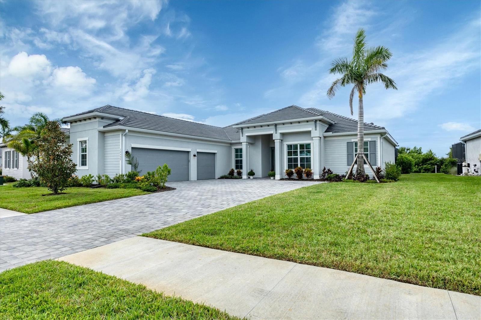Stately and stunning, this Napoli II model, estate home is located in the premier, resort-style community of Wellen Park Golf & Country Club, with a deeded golf membership—just pay a cart fee to play! Situated on a premium private lot with serene nature preserve views and nestled on a quiet street, this 4BR/2.5BA residence offers the ideal blend of elegance, comfort, and low-maintenance living. Enjoy impact-rated windows and sliding glass doors for your peace of mind, wood-look ceramic tile flooring, soaring ceilings, and a spacious 3-car side-load garage. The open-concept layout flows seamlessly from the chef’s kitchen—featuring quartz countertops, custom cabinetry, and high-end appliances—into generous living and dining areas. Pocket sliders lead to a beautiful outdoor oasis with a heated pool and spa, perfect for entertaining or relaxing in private. The serene and relaxing primary suite is a true retreat with an abundance of space with a reading nook, and a clear view French door leading to your luxurious pool and have blinds between the glass for privacy, and an ensuite bathroom just steps away. The spa-like bathroom includes a soaking tub, large shower, and dual vanities. The 4th bedroom is an added bonus with double French doors which can also be used as den or home office. Two additional guest bedrooms are thoughtfully separated for privacy, ideal for when friends and family come to visit! Living in Wellen Park Golf & Country Club means enjoying resort amenities, including an 18-hole Gordon Lewis-designed golf course, heated community pool, tennis, pickleball, bocce, tiki bar, salon, spa, state-of-the-art fitness center, dog park, social events, and miles of walking/biking trails. Low HOA dues include your golf membership, gated access, lawn maintenance, irrigation water, cable, and internet.  Wellen Park Golf & Country Club offers a vibrant lifestyle with world-class amenities, Located just minutes from downtown Wellen Park include dining, shopping, concerts, yoga on the great lawn, and CoolToday Park, home of the Atlanta Braves spring training. Venice’s pristine beaches and historic downtown are just 20 minutes away. Enjoy the ultimate Florida lifestyle with peace, tranquility, and world class amenities all in a maintenance-free, gated community. Just bring your bathing suit—this executive home is ready for you! NOTE: CDD fee is included in the taxes, and your golf membership is included in your HOA dues. HOA fee also includes basic cable and internet. Welcome Home to Wellen Park Golf & Country Club—where every day feels like a vacation!