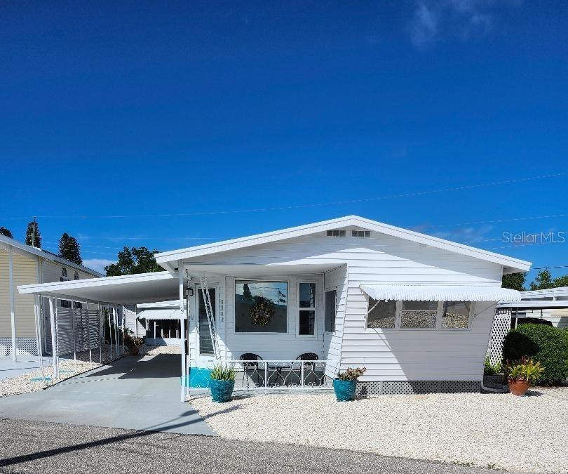 Steps Away from the sparkling waters and spectacular sunsets of Sarasota Bay! Prime location!...just across the street from the community pool, recreation buildings, shuffleboard and fitness center of the highly desired, active 55+ Trailer Estates community. Light, bright open concept living, dining and kitchen; this 1 Bedroom, 1 Bath Classic Vintage Mobile Home is newly updated with new laminate floors throughout, new kitchen cabinets, new backsplash, new range and refrigerator. New portable AC in living room. Freshly painted inside and out. Relaxing Screen Porch/Breezeway has new indoor/outdoor carpet and washer/dryer hookups. Rear deck to sun or entertain your family and friends. 6 x 7 Shed/Workshop. You own the land. Boaters have direct access to Sarasota Bay from the Marina. Enjoy the large, heated community pool, hot tub, gym and wood shop. The community buzzes with pickleball, shuffleboard, kayaking, horseshoes, bocce, dancing and more. A US Post Office on site. 10 minutes to the SRQ Airport. Convenient to shopping, restaurants, the Arts and everything in/around Bradenton/Sarasota. Sold AS-IS with right to inspect. Sold unfurnished.