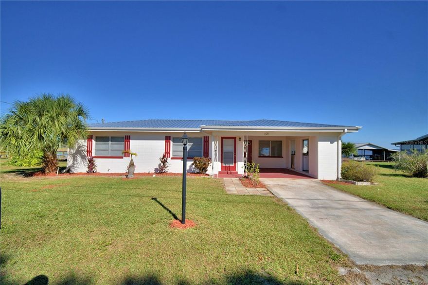 Lakefront home on Lake Reedy.  This 3 bedroom 1 bath concrete block home has a brand new metal room.  (Oct. 2025).  105' of lakefront with 2 slip boat dock.  The dock is 65' long with landing is 15 X 16 so plenty of room for fishing or relaxing and watching the sunrise.  There had been power at the dock.  Updates to the home include electrical with 200 amp panel, plumbing updates in the bathroom, Carrier AC installed around May or June of 2025.  Irrigation well has new pump but owner has never used the irrigation.  Special features are gas stove in the kitchen with small tank and lake view, gutters, city water and sewer, storage shed with new roof, enclosed back porch, and landscaping.  The back open porch is 12 X 4 with hand rail and steps leading out to the dock.  Terrazzo flooring throughout, some rooms have been freshly painted, laundry is in the one car carport, the large 23 X 12 enclosed back porch affords amazing views of the lake with windows on 3 sides.  See video link