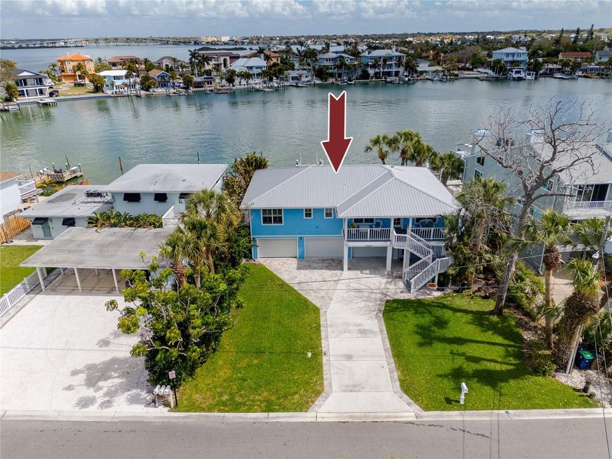 Rare waterfront opportunity in Indian Rocks Beach: A 3-bedroom, 2-bathroom home featuring 73 feet of Intracoastal water frontage. Perfectly positioned on a calm inlet, this property is a boater’s dream, equipped with a updated private dock and a 9,000lb lift keeping your vessel ready for sunset cruises or offshore fishing in the Gulf at a moment's notice. Designed for both relaxation and resiliency, the home boasts an expansive covered rear deck perfect for your morning cup of coffee or evening cocktails and an oversized hot tub with panoramic water views. A paver walkway, firepit, and alfresco dining area round out a backyard built for enjoyment. Inside, the 1,624 square feet of elevated living space is designed to keep the water front and center. Multiple French doors open the rear of the home to the deck, engineered hardwood floors carry through the main living areas, and the kitchen anchors the open-concept space with solid surface counters, updated appliances, and an easy flow into the dining and living rooms. Plantation shutters, updated lighting, and newer ceiling fans throughout give the interior a clean, coastal finish. The primary suite sits upstairs with a walk-in closet and serene inlet views. The ground level combines a two-car garage with additional storage space . Perhaps most importantly, this home remained high and dry through recent hurricanes, and it carries an assignable flood insurance policy at approximately $900 per year, a number that speaks for itself on an Intracoastal address in Pinellas County. The investment profile is equally clear. No HOA, no minimum lease period, a metal roof, a seawall updated in 2019, and a proven short-term rental history with projected annual revenue of $90,000 or more. A few blocks to the sand, dining, and shops along Gulf Boulevard, with easy access to Clearwater Beach and the broader Indian Rocks corridor. Don’t miss this low-maintenance, move-in-ready beach house in one of Pinellas County’s most sought-after golf-cart-friendly communities.