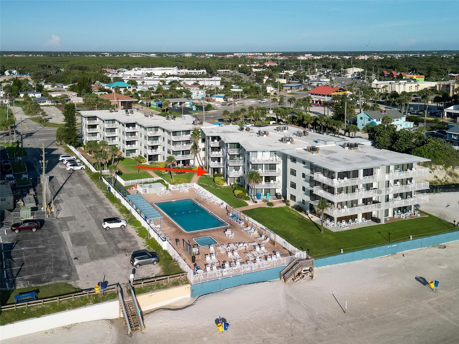 Enjoy stunning pool and ocean views from this beautifully updated first-floor condo in the heart of New Smyrna Beach. Located less than a mile from lively Flagler Avenue, this fully furnished unit combines a relaxed beach vibe with modern updates, including sleek porcelain tile floors, impact windows, and a 2022 HVAC system. Step out to your private patio with direct access to the heated pool, lush courtyard, and the sandy beach just beyond. This turnkey property has a proven rental history, making it ideal for investors seeking reliable income, those looking for a second home, or families wanting a place to make memories while offsetting costs through rentals. Inside, you’ll find a full-size washer and dryer, thoughtfully chosen coastal furnishings, and everything needed to move right in or start generating income immediately. Ocean Reef is a well-managed, low-rise community offering a large pool, tennis courts with pickleball lines, a covered grill area, a golf cart charging station, and on-site management for peace of mind. Fiber optic internet and two DirectTV boxes are included in the monthly fee, along with plenty of parking options (some covered). Experience the perfect blend of convenience, comfort, and coastal charm—schedule a showing today and see why this condo is a standout opportunity in New Smyrna Beach.