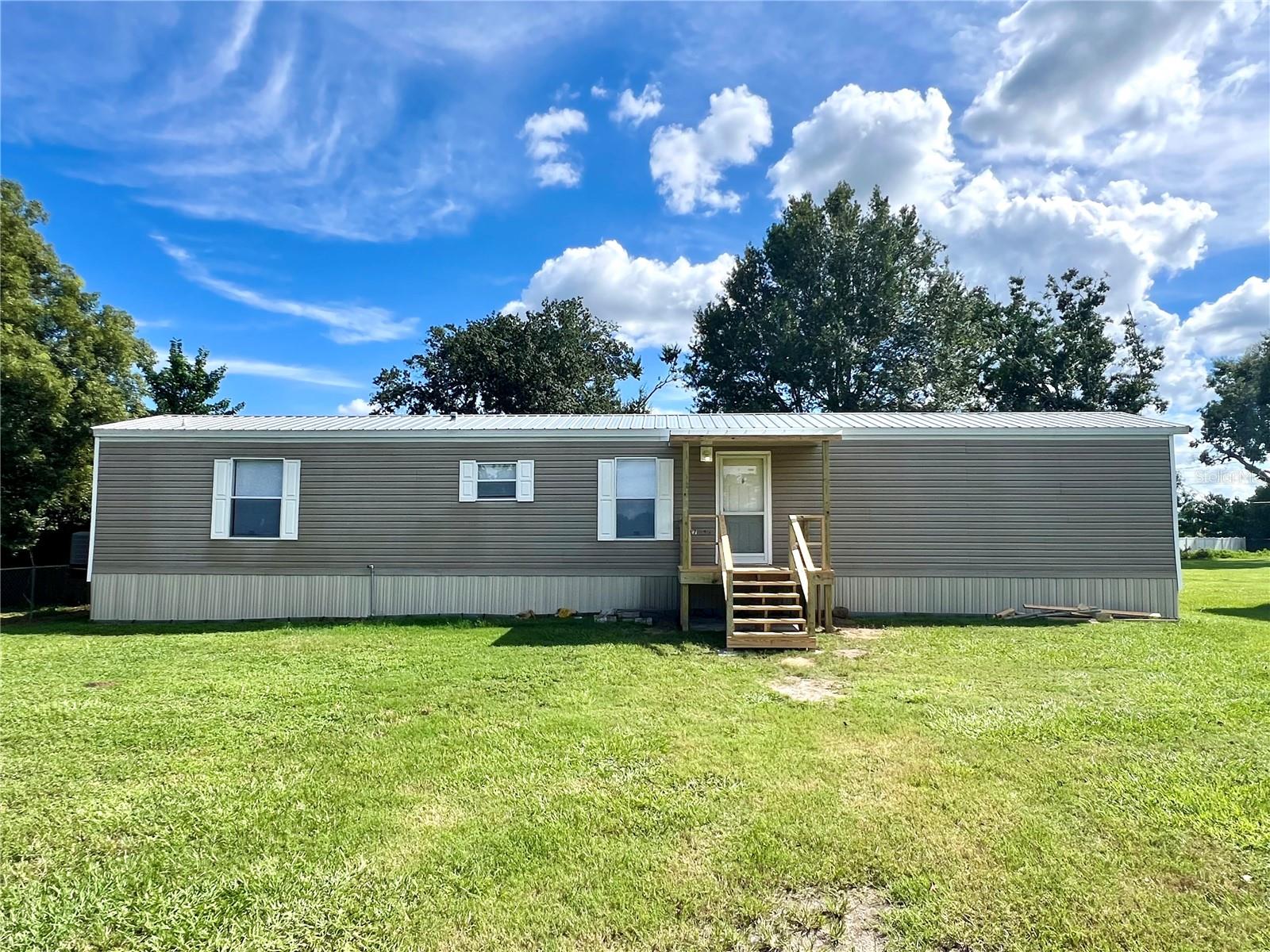 You must see this lovely 3 bedroom 2 bathroom manufactured home located south Lakeland. This completely remodeled home boasts a new metal roof, new flooring, appliances replaced in 2023, and a new porch. The home has a large backyard with mature shade trees. The property is conveniently located to many shopping centers, parks, grocery stores, and the Polk Parkway for easy commutes to Orlando and Tampa. Set up your showing today.