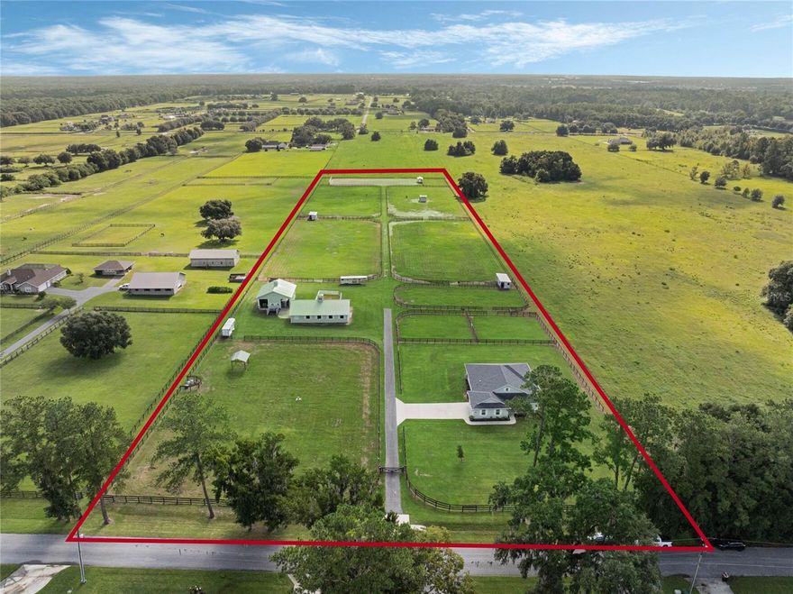 Welcome to this magnificent 10.5-acre farm, perfectly situated just minutes away from Golden Ocala and The World Equestrian Center. This beautifully manicured property offers an unparalleled blend of luxury and functionality.  The gorgeous home, built in 2021, boasts 3 bedrooms and 2.5 bathrooms, thoughtfully designed with an open-concept layout that seamlessly integrates the living, dining, and kitchen areas. Adorned with granite countertops and modern finishes, the kitchen is a culinary masterpiece. Step outside to the screened Florida room, a serene oasis for enjoying breathtaking sunrises over your picturesque farm, perfectly perched on a hilltop.  The stunning 7-stall center aisle barn features impeccable tongue and groove woodwork, along with a grooming stall, wash rack equipped with hot and cold water, tack room, deluxe stall mattresses, automatic waters, fans, and an automatic fly spray system.  Additional amenities include a separate equipment building complete with a bathroom, washer and dryer, and ample room for all your storage needs. The property also boasts a Longwood 100' x 230' irrigated arena, featuring GGT all-weather footing, mirrors, and a viewing stand. This property is an equestrian dream, blending elegance and practicality in NW Ocala’s horse country. Come experience equestrian living at its finest.