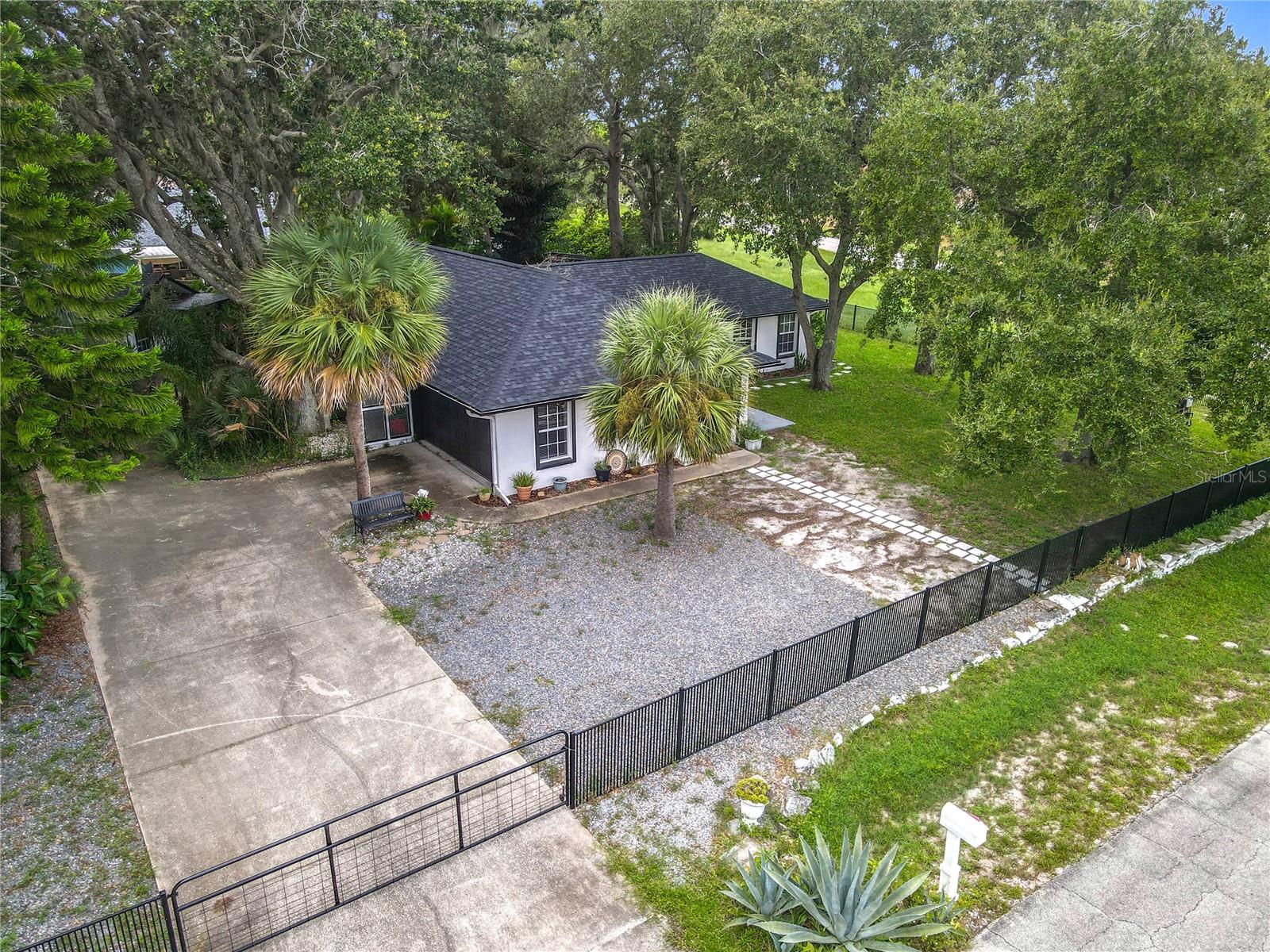 One or more photo(s) has been virtually staged. Rare triple corner lot in Florida Shores, NO FLOODING! This fully remodeled 3 bed / 3 bath home offers flexible living with a private-entry in-law suite + kitchenette, perfect for guests or multi-gen living. Inside, enjoy an open floor plan, pet wash station, and updated finishes. Outside, relax on the screened-in patio, park your RV with the 30-amp hookup, and take advantage of a detached “she shed”/office with A/C and hardwired Ethernet. MAJOR UPGRADES: New roof 2020, new appliances, 2-car finished garage, fenced yard, storage shed, no HOA, and high-and-dry lot—this home has it all!