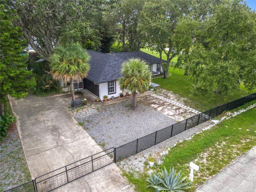 One or more photo(s) has been virtually staged. Rare triple corner lot in Florida Shores, NO FLOODING! This fully remodeled 3 bed / 3 bath home offers flexible living with a private-entry in-law suite + kitchenette, perfect for guests or multi-gen living. Inside, enjoy an open floor plan, pet wash station, and updated finishes. Outside, relax on the screened-in patio, park your RV with the 30-amp hookup, and take advantage of a detached “she shed”/office with A/C and hardwired Ethernet. MAJOR UPGRADES:  New roof 2020, new appliances, 2-car finished garage, fenced yard, storage shed, no HOA, and high-and-dry lot—this home has it all!