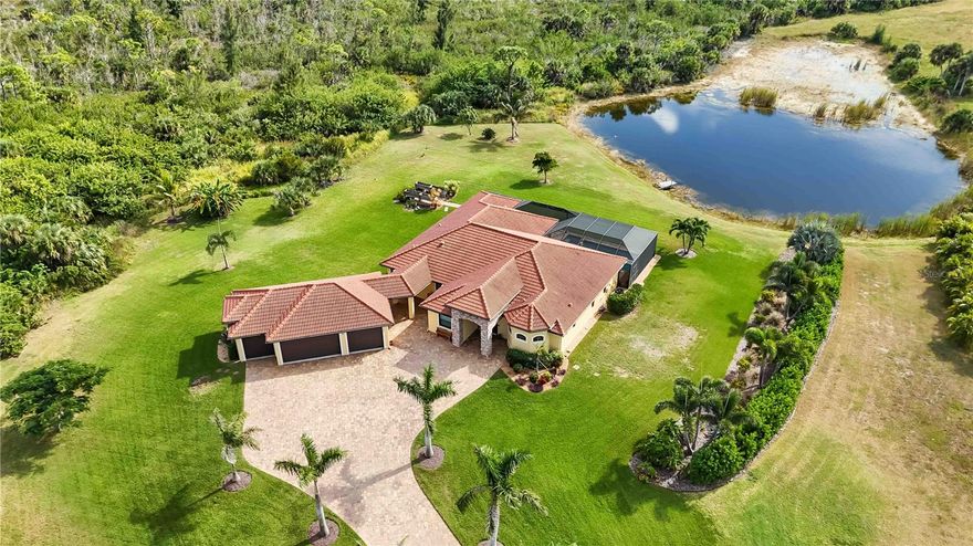 One or more photo(s) has been virtually staged. Discover a one-of-a-kind opportunity in the exclusive equestrian community of Gasparilla Preserve! Set on over 5 acres of private, pond-front land, this Mediterranean-inspired ranch blends luxury, space, and nature just minutes from Boca Grande’s sugar-sand beaches, Coral Creek Airport, and top-tier golfing at Coral Creek Club.

Built in 2019 with solid CBS construction and hurricane-rated Energy Star windows, this 3-bedroom + office + bonus room estate is storm-ready and built to impress. Inside, an open-concept design highlights a gourmet kitchen with rich wood cabinetry, stone counters, stainless appliances, a walk-in pantry, and an oversized island perfect for entertaining. The kitchen flows seamlessly into a spacious great room with soaring ceilings and pocket sliding doors that open wide to the resort-style lanai.

The primary suite is a dream with double walk-in closets, a spa-worthy bathroom featuring a freestanding soaking tub, dual vanities, and a natural stone walk-through rain shower. Guests enjoy two generous bedrooms with a shared bath, while the separate office and billiard room add flexible living options.

Outside, unwind in the screened saltwater pool and spa with panoramic views of your own pond and the peaceful preserve beyond. Entertain year-round with an outdoor kitchen, covered patio, and multiple seating areas. The 4-car garage with additional workshop space is ideal for equestrian gear, tools, or toys.

Gasparilla Preserve is a gated, HOA-protected enclave designed for those who value privacy, architectural integrity, and connection to the outdoors. With non-motorized boating, fishing, and horse-friendly zoning, every detail invites you to live fully and freely.

Don’t miss your chance to own this rare slice of Florida paradise—book your private showing today!
