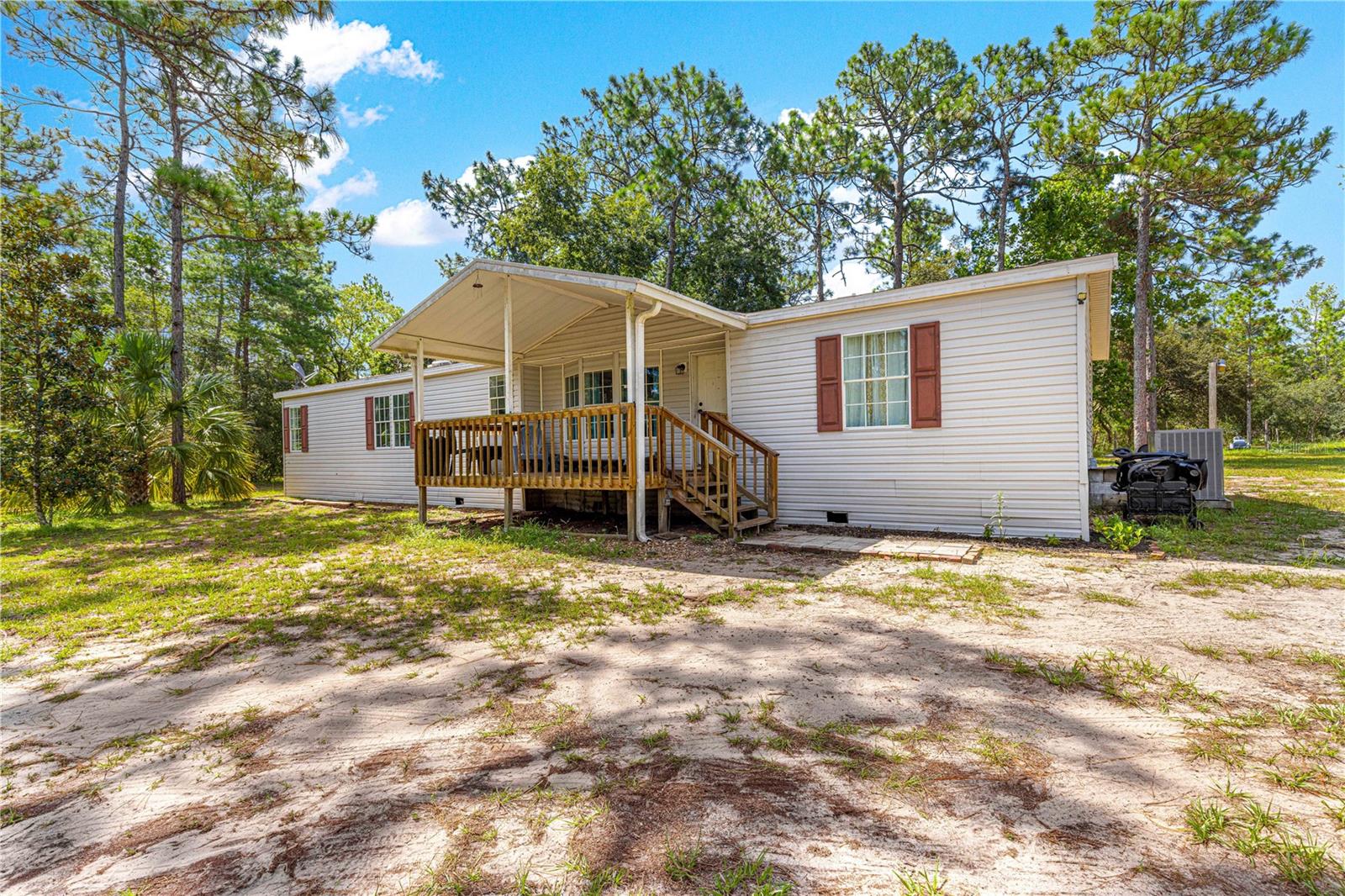 Welcome Home to Your Private 5-Acre Retreat in Ocklawaha! This charming 3-bedroom, 2-bath home with a versatile bonus room offers the perfect blend of space, comfort, and freedom. Step inside to find an open-concept layout ideal for entertaining, complete with a cozy wood-burning fireplace for those cooler Florida nights. Outside, the entire property is fully fenced, making it the perfect place to bring your toys, animals, fruit trees, friends, and family. Whether you’re dreaming of a hobby farm or simply wide open space to roam, you’ll love the possibilities here. Enjoy peaceful mornings on the spacious front porch as the sun rises, and unwind in the evenings while watching the sky fade into twilight. Located near Lake Weir and the Ocala National Forest, your opportunities for outdoor adventure are endless. And with easy access to Lady Lake, The Villages, and Ocala, your next direction is entirely up to you. Tractor is also for sale separately.