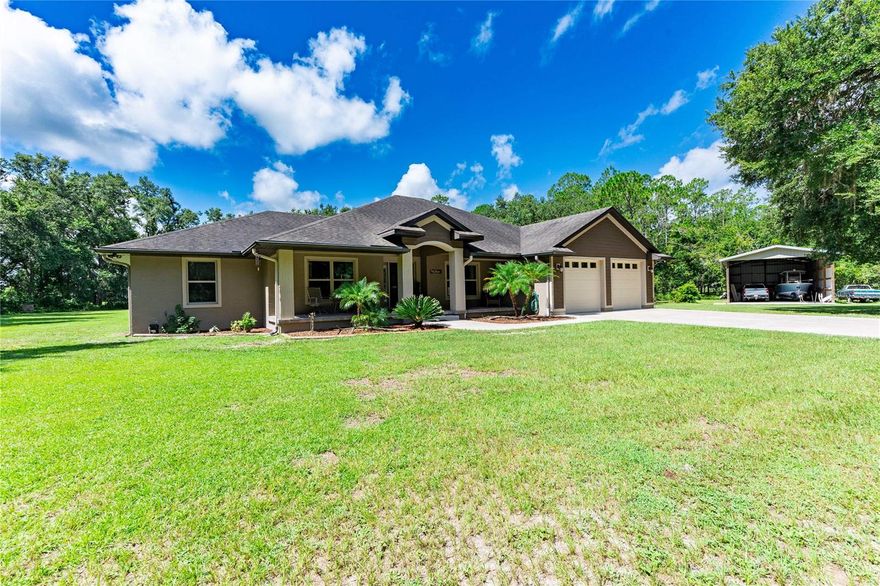 Escape to your own private paradise with this stunning 3-bedroom, 3-bathroom custom home, built in 2015 and nestled on 5 acres at the end of a quiet dirt road. Offering 2,440 square feet of thoughtfully designed living space, this property combines luxury, functionality, and total privacy — all just minutes from I-75.
Step inside and fall in love with the cathedral ceilings, open floor plan, and abundant natural light. The heart of the home is the huge chef’s kitchen, featuring stone countertops, a massive center island, stainless steel appliances, and a huge pantry perfect for culinary enthusiasts and entertainers alike.
The spacious primary suite offers a true retreat with a spa-like bathroom and ample closet space. Two additional bedrooms and a dedicated office provide plenty of room for family, guests, or working from home.

Enjoy year-round Florida living in the screened-in in-ground pool with spa, perfect for relaxing or entertaining, especially with the expansive seating area and perfect outdoor kitchen space. The adorable front porch offers peaceful views of your expansive property.
Additional features include:
    •    No HOA, no deed restrictions – bring your toys, animals, or build your dreams
    •    24 x 48 Pole barn with concrete floors – ideal for storage, workshop, or hobbies
    •    Indoor laundry room
    •    2-car garage
    •    Easy access to I-75 for commuting, shopping, and dining
This one-of-a-kind property offers the best of both worlds: peaceful country living with modern conveniences and excellent location. Don’t miss this rare opportunity!