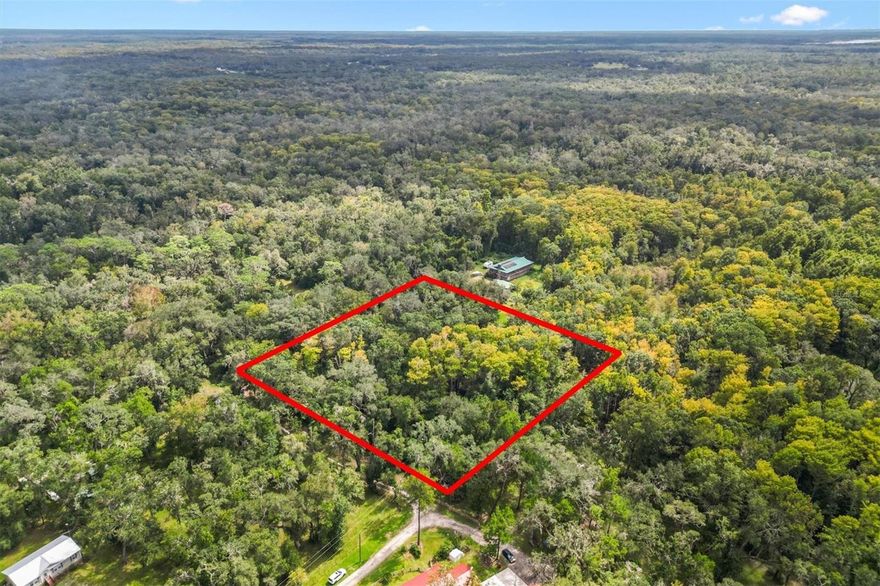 Build your dream home on this pristine 2.53-acre canvas in one of Croomacoochee's most desirable neighborhoods. Unlike typical rural parcels, this unimproved lot sits on a well-maintained lime rock road surrounded by quality homes, offering the perfect blend of country space and neighborhood pride. Located just off the main road with convenient access to US Highway 301, you'll enjoy easy commuting while maintaining your rural lifestyle. This area is an outdoor recreation paradise near the 20,000-acre Croom Wildlife Management Area, providing direct access to miles of hiking, biking, and equestrian trails along the scenic Withlacoochee River. With I-75 just 4 miles away, you're an hour or less from both Tampa and Orlando. No HOA restrictions give you the freedom to design your estate exactly as you envision, whether that's a custom home, hobby farm, or private retreat. This is country living done right—space, quality neighbors, and nature at your doorstep.