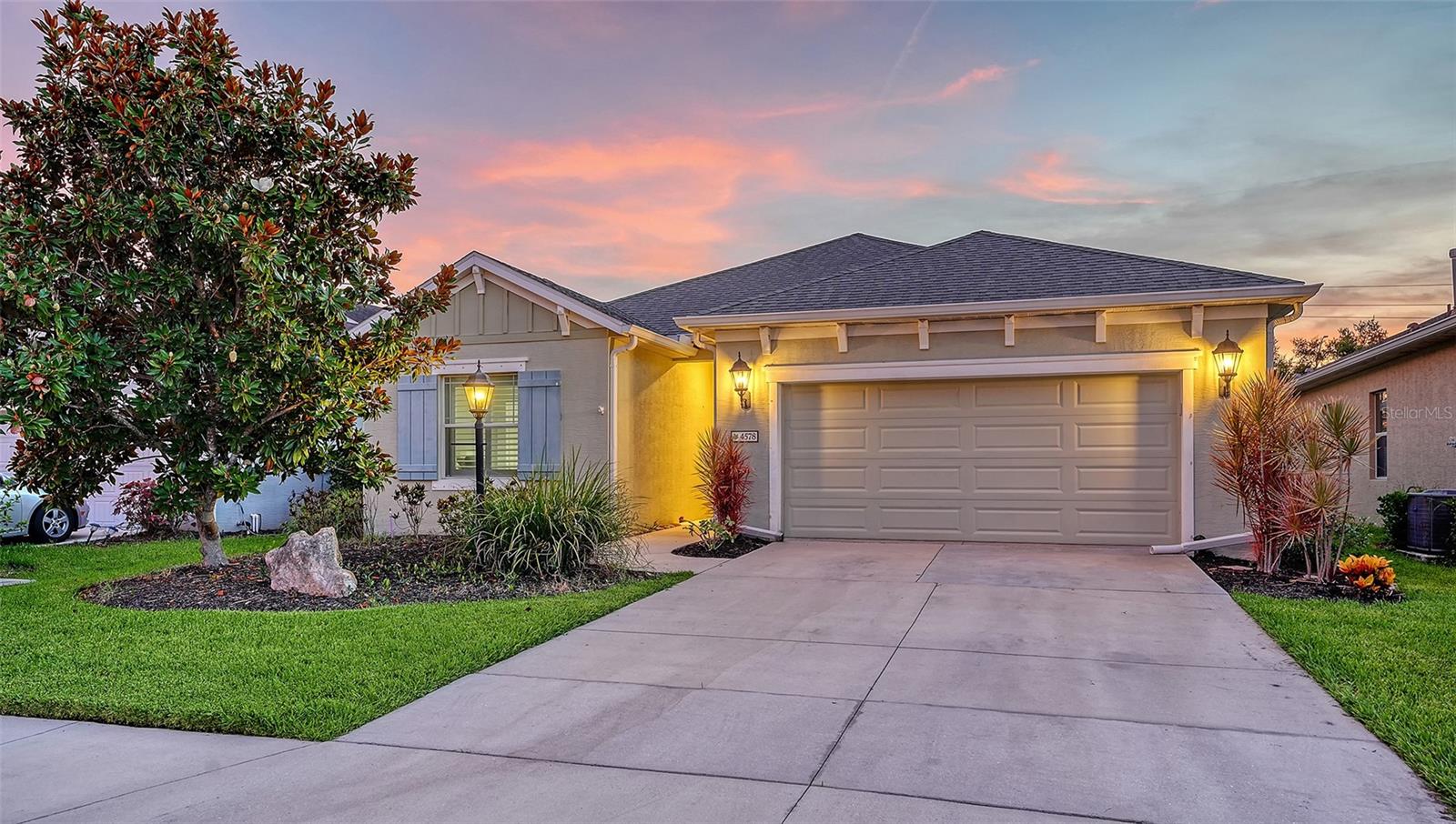 Stunning home located in the serene gated Woodbrook community. Built in 2015 with over 1,552 SF of open living space, this meticulously maintained pool home includes a private fenced backyard retreat for privacy. Charming 3 bedrooms and 2 baths designed for comfort. Step inside to find thoughtful upgrades throughout, including plantation shutters, detailed wall accents, newer interior paint and much more. The open-concept great room features a stylish tray ceiling, feature wall, and sliding glass doors that lead seamlessly to the bronze cage-screened lanai with a heated saltwater pool and spa—perfect for year-round enjoyment. The chef’s kitchen impresses with upgraded cabinetry, granite countertops, a tile backsplash, and newer stainless-steel appliances, all complemented by a spacious dining room ideal for entertaining. The primary suite offers comfort and privacy with two walk-in closets and a luxurious en-suite bath complete with a frameless glass walk-in shower. Two additional bedrooms and a full bath are thoughtfully situated to provide privacy for family or guests. Residents of Woodbrook enjoy access to resort-style amenities including a pool, spa, grill area, playground, park, and scenic sidewalks throughout this beautifully landscaped, gated community. Conveniently located near world-class shopping at UTC, fine dining, cultural entertainment, downtown Sarasota, the pristine Gulf Coast beaches, numerous golf courses, Sarasota-Bradenton International Airport, Benderson Park and so much more. Come experience the best of Sarasota living in this move-in ready home that combines comfort, privacy, and style in a prime location.