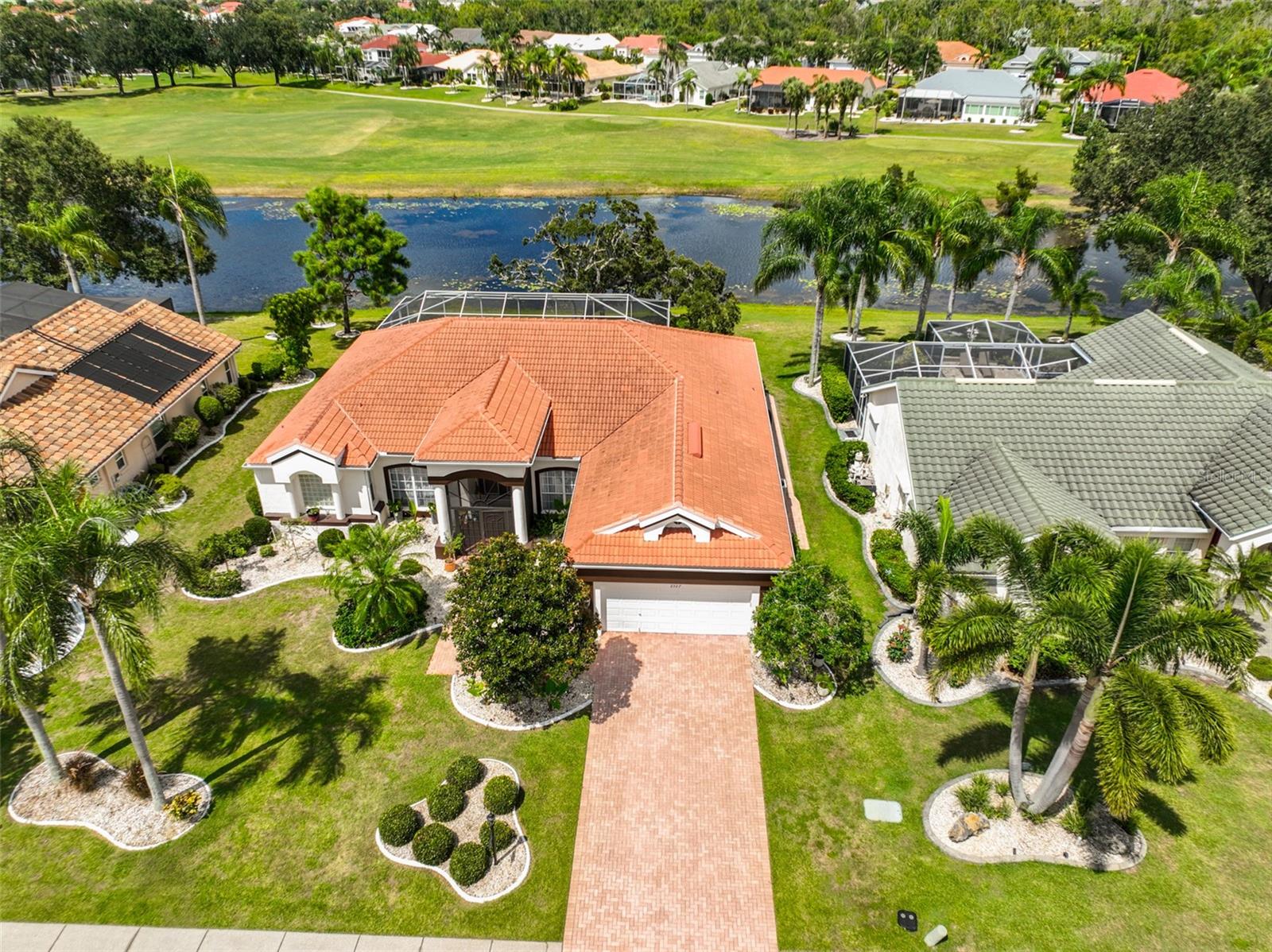 Click On 3D Tour Above -------- STUNNING & COMPLETELY RENOVATED, EXECUTIVE POOL HOME WITH TERRIFIC WATER & GOLF COURSE VIEWS! Welcome to this immaculate & perfectly maintained Floridian paradise, located in a desirable area within the active & friendly 55+ community of Sun City Center. You'll love the lush landscaping, brick paver driveway, refreshed exterior paint (2025) & lighting (2024), inviting screened entryway (2024) and TILE ROOF (2018), all giving this home amazing curb appeal. Step inside where you'll be drawn to the terrific views all across the rear of the home. The comfortable living room has gorgeous solid ash hardwood herringbone flooring (2024) and triple sliders leading out to the lanai area. The fabulous custom & re-designed eat-in kitchen (2025) is a cook's dream with Kraftmade solid wood cabinetry, quartz counters & backsplash, Frigidaire Gallery stainless appliances, induction stove with air fryer, porcelain tile flooring, large island for extra seating & storage, and a cozy eating area overlooking more terrific views. The private owner's suite (2025) boasts porcelain tile flooring, custom walk-in closets & lighting, walk-in tile & glass shower and even has an additional outside wall for extra quiet nights. The other 2 spacious bedrooms & guest bathroom have also been refreshed (2025) and are at the opposite end of the home giving more privacy for quests. The den/office is light & bright and would make a great 4th bedroom if needed. Even the inside laundry room has been nicely updated (2025). Other recent home upgrades are, Leaf water softener & whole house water filtration w/UV light (2024), whole house re-pipe (2024), electrical panel, outlets & electric car charging station (2024) and interior paint (2025). When you want to relax, retreat to the fabulous lanai area where you can lounge poolside and enjoy the serene water & golf course views of the 10th fairway of the Renaissance Golf Course. For added safety, an AUTOMATIC HURRICANE LANAI SCREEN (2024) has been added to create a "STORM SAFE AREA". This home is just a short golf cart ride to the numerous Sun City amenities such as shopping, restaurants, banking, doctors, various social clubs, gym, pickleball, and so much more. The house is also just down the road from the optional Club Renaissance, where you can enjoy dining, cocktails, social activities and more. So come and view this amazing home and see why you'll want to call it yours!