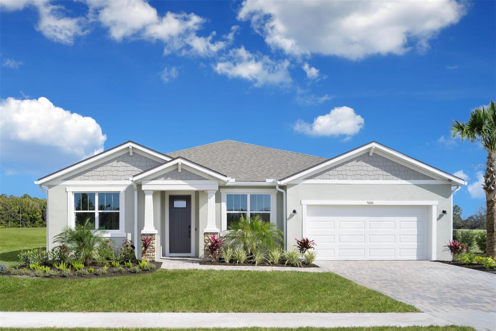 Welcome to The Red Rock Model Home Craftsman style plan, an exceptional home located in the gated community of Windwater in Parrish, FL. This beautifully designed property offers 3,057 square feet of luxurious living space, featuring 4 bedrooms, 3.5 bathrooms, a study and oversized flex room, and a 3 car tandem garage. This home is perfect for those seeking elegance and comfort.
Upon entering, you'll be greeted by an open floor plan with 8' doors that seamlessly integrates the main living areas, adorned with engineered wood flooring for a modern and cozy look. The executive kitchen with super island is a culinary masterpiece, boasting 42" Sonoma painted Boulder cabinets and exquisite Calacatta Ultra quartz countertops, ideal for both everyday cooking and entertaining guests. The kitchen comes complete with all upgraded stainless steel appliances, including glass cooktop with hood vent exterior vented, wall oven and microwave and refrigerator.
The master suite is a private haven, complete with a spacious bedroom and a luxurious en-suite bathroom featuring split vanities, and a spacious glass enclosed Super shower with two shower heads and dual walk-in closets. The additional bedrooms are well-appointed, ensuring comfort and privacy for family members and guests. The Flex Room area offers a versatile space for relaxation or work.
The protected covered screened in lanai, accessible through sliding glass doors in the great room, provides an ideal setting for outdoor living and entertaining. Whether you're hosting a gathering or enjoying a quiet evening, this space enhances the indoor-outdoor living experience. Move in ready, furniture is not included. Home is being sold as-is. Photos, renderings and plans are for illustrative purposes only and should never be relied upon and may vary from the actual home. Pricing, dimensions and features can change at any time without notice or obligation. The photos are from the furnished model home, but the furniture, electronics or furnishings do not transfer with the sale of the home.
