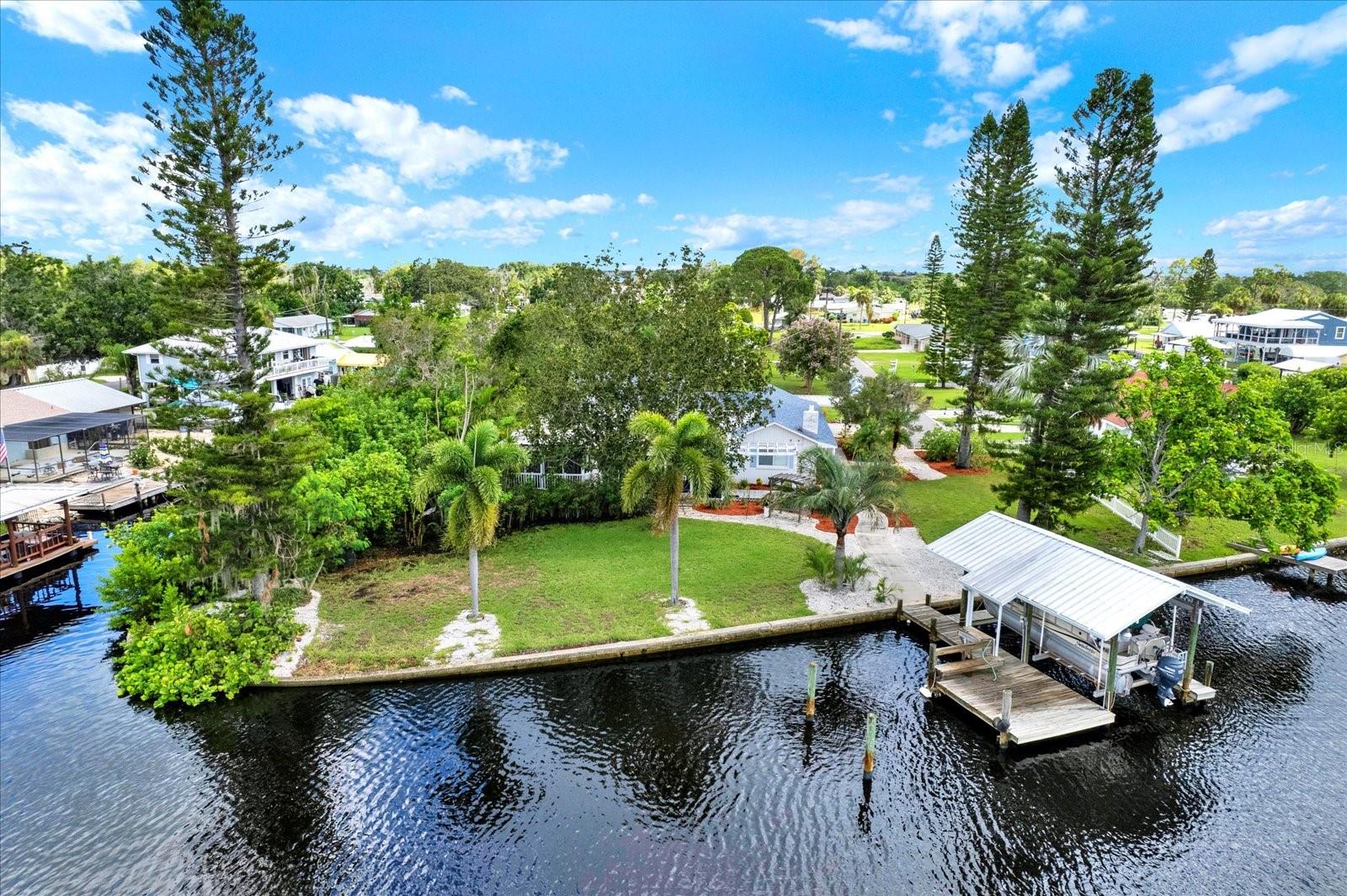 One or more photo(s) has been virtually staged. If you dream of owning private and pristine Florida waterfront, this property might be for you. Fish the pristine waters of the Little Manatee River or the nearby islands of Cockroach Bay Preserve, at the River's mouth in Southeast Tampa Bay, No HOA or CDDs.
This 0.6156-acre parcel is situated at the base of the Ruskin Inlet on the Marsh Branch of the Little Manatee with a straight shot into the main river and out to Tampa Bay and Beyond. The property angles southwesterly 134 feet along the riverfront then 244 feet northerly along the Canal. There is a 7500lb boat lift and dock on the riverfront. On the canal you will discover a timeless boat house with a 25 ft boat slip, fish cleaning station and plenty of space to organize all of your boating, kayaking and fishing gear. Included beyond the boat house lies an approx 85ft bonus vacant buildable canal front parcel.
The 2 bd 2 bth block home is designed for maximum entertaining. It has been completely updated over the past 9 months to include a vast new Chef's kitchen with breakfast area, new appliances, new cabinets, granite counters, walk-in pantry, two ovens, and serving window counter space opening to the expansive screened rear covered patio with its own impressive stone barbeque. A trio of informal open plan gathering areas, all with stunning river views, include a living room with a magnificent floor-to-ceiling stone fireplace, an inviting dining area and a bright sunny Florida room, all leading to a screened river-facing front patio and elevated screened deck. The home has storage galore and the floors are covered in tile and beautiful commercial vinyl plank. Conveniently located near US-41 and I-75, making Bradenton, Sarasota, and Tampa an easy drive for shopping, beaches, and restaurants. Schedule a showing today.