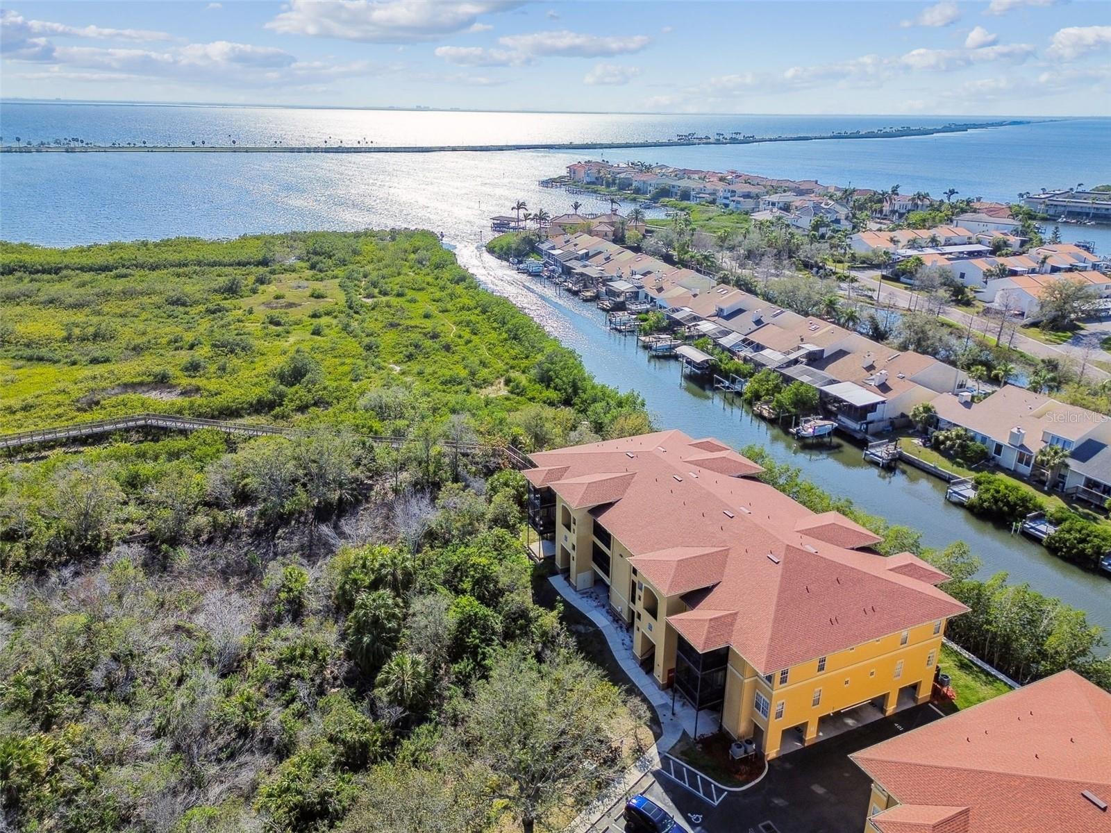 WATER VIEWS OF THE BAY!!!!!!!! FULLY FURNISHED CONDOMINIUM!! Located minutes from Tampa International Airport, Westshore Business district, shopping and restaurants! Fantastic floor plan with split bedrooms and OPEN CONCEPT LIVING SPACE! TOP FLOOR!!! Fully equipped kitchen with all new sleek stainless-steel appliances! Kitchen is FULLY stocked with all the kitchenware you desire! WATER VIEWS OF THE BAY!!!!!!!! Spacious living room with French doors leading to your PRIVATE SCREEN ENCLOSURE! Enjoy views of the bay and nature ! Outdoor furniture all included! Two primary suites with walk-in closets and bathrooms. NEWER HVAC SYSTEM!! AMAZING natural light throughout this sensational condo! AGAIN, FULLY FURNISHED!! Communities' amenities include spectacular boardwalk .... resort style pool.....fitness and clubhouse. Beachwalk is a GATED community! Come tour this fantastic fully furnished condo ..... even beach balls and chairs included!!! WATERFRONT LIFE AT ITS FINEST!!