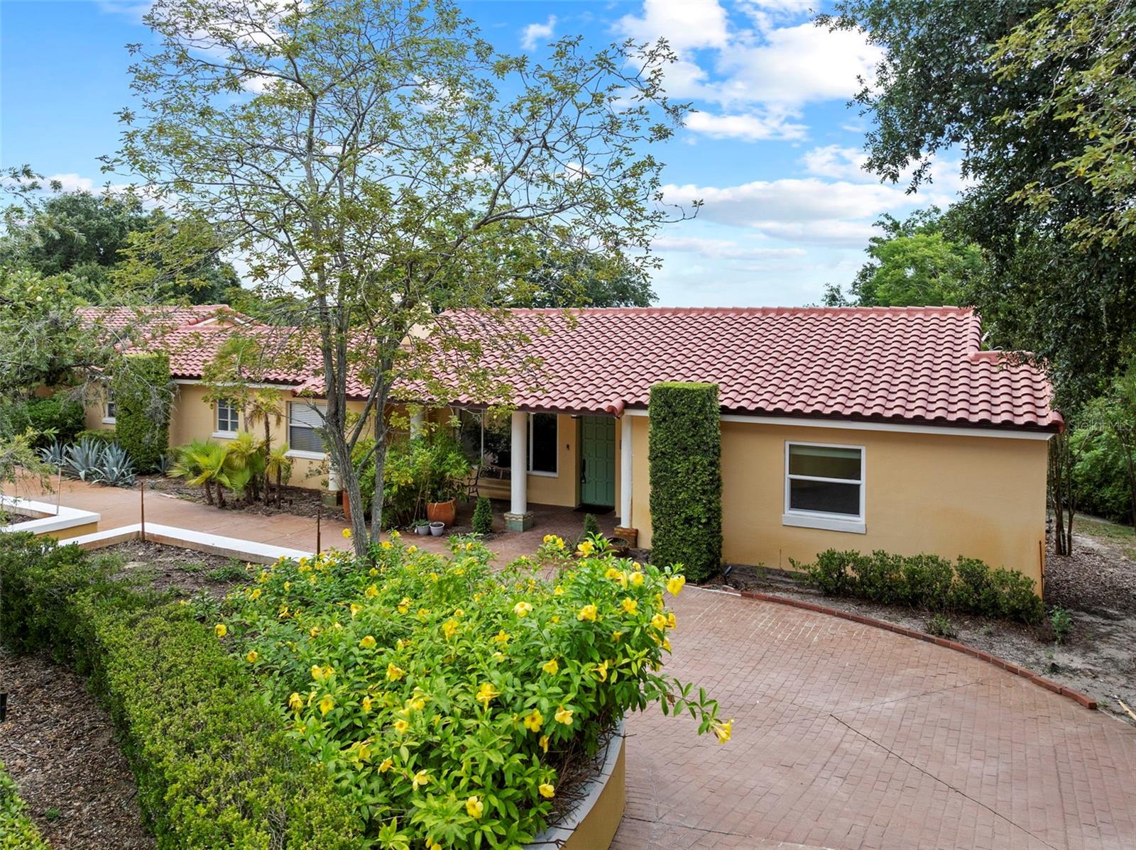 Welcome to this stunning 3-bedroom, 3-bathroom Mediterranean-style home, offering a spacious 2,667 sq ft of living space nestled on a serene 0.69-acre lot. Just 5 minutes from the iconic Bok Tower Gardens and 4 minutes to shopping and dining, this home perfectly blends convenience with timeless elegance.
From the moment you arrive, the new tile roof, brick-paved driveway, and mature landscaping set the tone for the beauty that lies within. Step inside to discover a unique floor plan filled with character and space—highlighted by a huge chef’s kitchen, ideal for entertaining or enjoying quiet evenings at home.
The magical backyard, complete with lake views, feels like a slice of Italy, offering a peaceful escape surrounded by lush greenery and old-world charm. The spacious master suite features a luxurious bathroom, providing the perfect retreat at the end of the day.
Additional features include a 2-car garage, access to Lake Wales, and close proximity to AdventHealth for added peace of mind.
This home is truly one-of-a-kind—where timeless Mediterranean beauty meets everyday functionality. Don’t miss your chance to own this hidden gem in the heart of Central Florida.