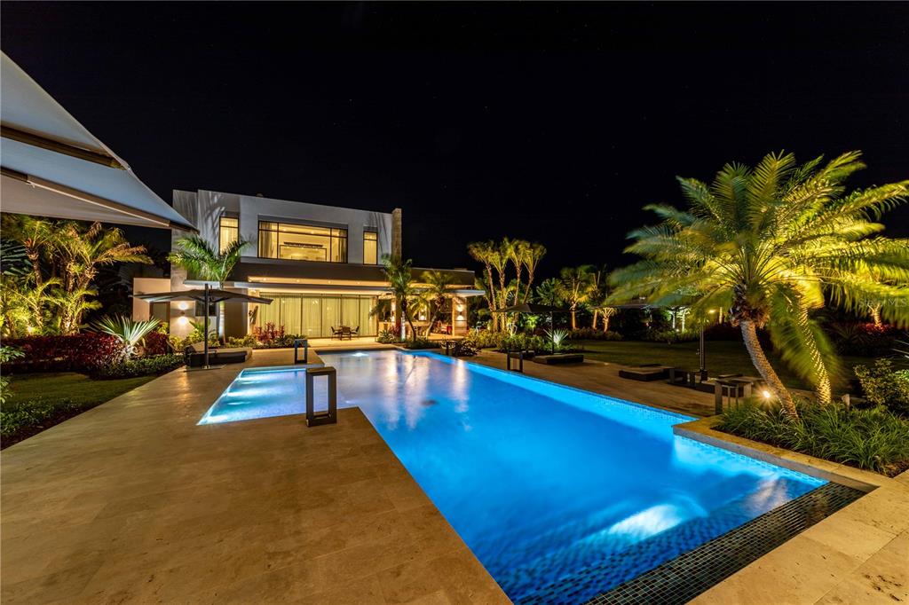 An exclusive offering at The Legacy awaits. Live luxuriously with an abundance of privacy and convenience at this vibrant new construction Dorado Beach home. It consists of the primary and detached entertainment building with 7,632 and 5,000 square feet. Built-in 2021 with high-end finishes and true quality craftsmanship can be throughout the home, this space is truly move-in ready. Hand-selected tile flooring, natural light, and elegant fixtures fill the open-concept entertaining spaces and private rooms, creating an elevated living experience. Your inner home chef will delight in taking advantage of the expansive kitchen designed with solid wood-style cabinets, spacious countertops, and a beautiful backsplash with views of the patio just beyond the kitchen from the sliding glass doors. The Legacy additionally offers a private bar area within the home with a custom-crafted Samsung TV -the first of its kind on all of the island. The adjoining living room provides a lovely backdrop for hosting loved ones as you enjoy time spent creating new memories and sharing laughter after a home-cooked meal with a bar and access to the patio through sliding glass doors.
Entertain outdoors in the sprawling surrounding oasis with functional and intricate landscaping that compliments the natural surroundings, including the patio with patio set and views of the luxury pool and cabanas. This lovely spot provides the perfect amount of shade combined with a subtle breeze to enjoy any warm PuertoRican day spent reading your favorite book, enjoying a meal al-fresco, or simply taking in the surrounding natural beauty. The owner's suite exudes a tranquil feeling with light and airy coloring, floor-to-ceiling windows overlooking the landscape, a deep closet, and an updated spa-like attached ensuite with many custom finishes. Work from home? The property provides work-from-home space secluded from the rest, allowing for privacy during zoom calls or other business meetings.
The surrounding neighborhood is one of Puerto Rico's most refined. Dorado boasts world-renowned beaches such as Balneario de Dorado and Playa De Sardinera, with beautiful beaches and stunning views of the turquoise waters. Spend your free time golfing at the Dorado Beach East Golf Course, shopping, or dining at some favorite local restaurants with traditional food. Noteworthy features of the property include access to building amenities such as a basement gym, elevators, a resort-style pool, and many other high-end facilities and events. This home is truly a once-in-a-lifetime opportunity to join the already sold-out community. All that's left for you is to pack your bags and start your next great adventure on Dorado Beach!