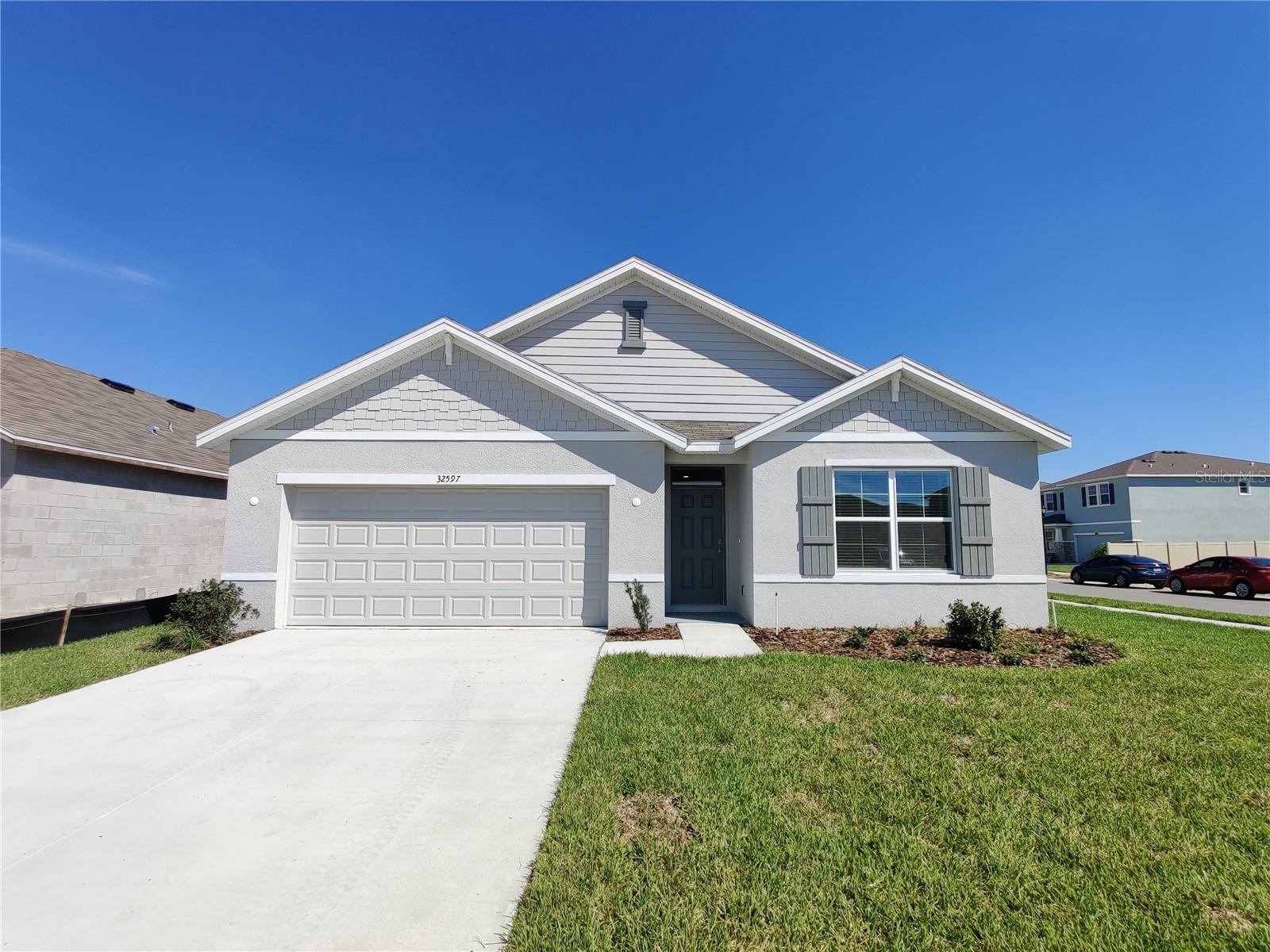 This stunning home, built in 2021 by DR Horton (Cali floor plan), is located in the desirable Union Park community of Wesley Chapel. Offering 1,846 sq. ft. of thoughtfully designed living space, it features 4 bedrooms, 2 full bathrooms, a spacious great room, dining area, breakfast nook, covered screened lanai, charming front porch with stacked stone accents, and a two-car garage.
Step through the welcoming foyer and you’ll immediately notice the high ceilings and open floor plan that create a bright and airy atmosphere. The gourmet kitchen is a true highlight, complete with granite countertops, tile backsplash, stainless steel appliances, pendant lighting, and elegant cabinetry with crown molding. A large center island and ample pantry space make it perfect for both cooking and entertaining. The breakfast nook opens to the covered screened lanai through sliding glass doors, leading to a partially fenced backyard—ideal for outdoor relaxation.
The primary suite offers a customized walk-in closet, plush neutral carpeting, walk-in shower, and dual vanities. Two additional bedrooms provide flexibility for guests, a home office, or a growing family. The conveniently located laundry room includes a storage closet and comes equipped with a washer and dryer.
Additional upgrades include Smart Home technology, tile flooring throughout the main living areas, and neutral carpet in the bedrooms. The home also includes Ultra WiFi internet with extended cable and Showtime.
Union Park is an UltraFi community offering resort-style amenities, including a clubhouse with a community pool, splash pad, fitness center, basketball courts, walking trails, picnic pavilion, playground, dog park, butterfly garden, and multiple outdoor fitness stations.
This location is incredibly convenient—just minutes from top-rated schools, Pasco-Hernando State College, AdventHealth and BayCare Hospitals, Wiregrass Mall, Tampa Premium Outlets, Krate at the Grove, the Ice Rink, Sam’s Club, Costco, movie theaters, and endless dining options. It also provides easy access to I-75, I-275, Tampa International Airport, Downtown Tampa, and Florida’s beautiful Gulf Coast beaches.