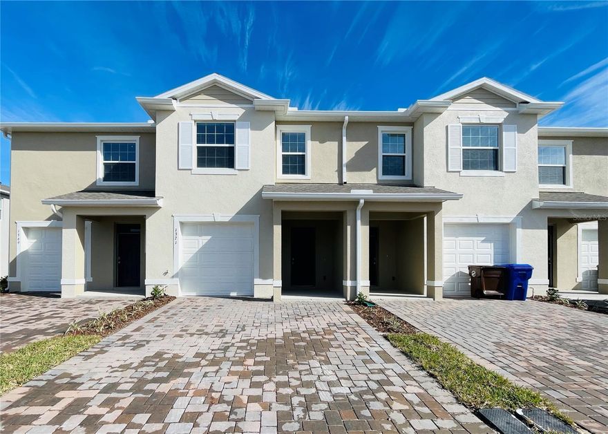 Almost like new and built in 2023, this beautiful townhome features a spacious open-concept floor plan designed for modern living and entertaining. The first floor offers a large family room overlooking the covered rear lanai, a stylish kitchen with stainless steel appliances, and a convenient powder room. Upstairs, the spacious primary suite features an ensuite bathroom, along with two additional bedrooms, a full bathroom, and a laundry area for added convenience. The community offers amenities including a beautiful pool and playground. Conveniently located near major highways, shopping, restaurants, and world-class attractions, this home combines modern style, comfort, convenience, and exceptional value. Call today for your private showing.