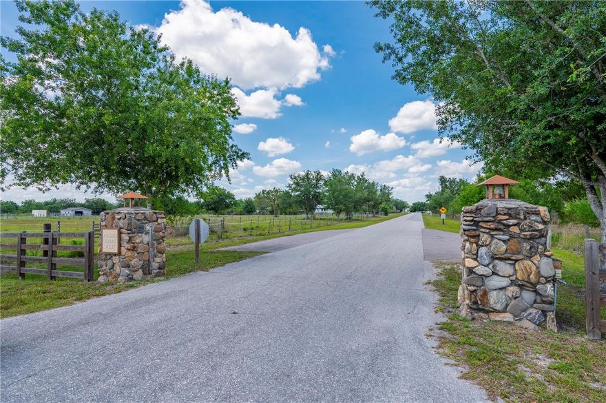 Discover country living at its best in the prestigious, deed-restricted equestrian community of Prairie Creek West. This exceptional 5.37-acre estate offers the perfect blend of rural tranquility and modern convenience, featuring paved roads and dedicated horse trails right at your doorstep. The property is fully fenced for privacy and includes a serene private pond, with the residence tucked away from the road to ensure a peaceful, secluded atmosphere.

The heart of the estate is a one-of-a-kind, custom-built home boasting 4,507 square feet under air and a durable metal roof. Designed with large families in mind, the versatile floor plan offers a minimum of five bedrooms and expansive living spaces. The layout includes a primary suite on the first floor, a ground-floor guest room, and a secondary bedroom suite with a private bath on the second floor alongside additional bedrooms. The main living area makes a grand impression with soaring ceilings, character-rich wood beams, and two-story windows that flood the space with light. A spacious kitchen with wood cabinetry and tile countertops is perfectly positioned for entertaining, situated between the formal dining room and the inviting Great Room.

Outdoor living is elevated by a massive 31'x46' screened-in lanai and an oversized pool, accessible via pocket sliders that seamlessly blend the interior and exterior spaces. It is the ideal setting for BBQing and enjoying expansive country views. Equestrian enthusiasts will appreciate the detached barn with carport, which has been converted into 2 open-air horse stables designed for fresh air and easy access. Completing the home is an oversized two-car garage and a large bonus room located off the main living area, providing ample space for hobbies, a home gym, or a private office.