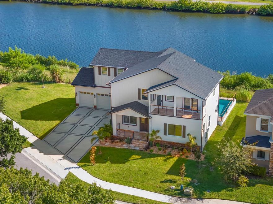 Under Construction. Welcome to 3426 Channelside in Safety Harbor and this exceptional brand-new custom residence that will be ready to move in mid Oct 2025. Located min from Mease Hospital. Perfectly situated on a spacious 0.25-acre lot on a tranquil canal in one of Tampa Bay’s most desirable towns—Safety Harbor. Offering over 3,448 sq. ft. of living space with 4 bedrooms, 4 full baths and 3 car garage with more than 5,000 sq. ft. under roof, this home was designed with both elegance and functionality in mind. Built high and dry to the latest building and safety codes, it features energy-efficient hurricane-rated windows, sliders, and doors throughout. The thoughtful floor plan includes two expansive primary suites, 2 additional bedrooms, and four full bathrooms across two levels, creating an ideal setting for multi-generational living or those seeking a luxurious retreat. As you arrive, you’ll be captivated by the home’s impressive curb appeal—complete with a large driveway accented by California design stone inlay, lush landscaping, and a three-car garage. The travertine walkway leads to large front porch and double front doors beneath a striking tongue-and-groove wood ceiling, complemented by cable railing systems and travertine porches that hint at the craftsmanship inside. Step into the open-concept great room where soaring beam-accented ceilings and a stacked-stone electric fireplace create a stunning focal point. Engineered hardwood flooring flows seamlessly into the chef’s kitchen, which showcases a massive waterfall quartzite island with backlit LED accents, abundant custom cabinetry, designer tile backsplash, and top-of-the-line GE Café refrigerator, a built-in oven, microwave, electric cooktop with pot filler, and custom vent hood. The adjoining dining area opens through sliders to the pool deck, covered porch area and backyard, creating effortless indoor-outdoor living. On the main level, one of two primary suites offers a serene escape with a spacious walk-in closet, spa-like en suite featuring double vanities, designer tile, oversized shower, water closet, and a private laundry area with full size washer and dryer hookups. A full pool bath with deck access adds convenience. Upstairs, a stylish loft leads to the second primary suite, complete with sliders to a private deck overlooking the canal, two walk-in closets with custom cabinetry, and a luxurious en suite with double vanities, designer finishes, freestanding tub, oversized European-tiled shower with dual showerheads, and a smart toilet. Two additional upstairs bedrooms share a well-appointed bathroom and each enjoy walk-in closets, ceiling fans, and access to a front balcony. Outdoor living is equally impressive with a sparkling pool and expansive travertine deck, ideal for entertaining or quiet relaxation. This prime location is just minutes from Mease Countryside Hospital, top-rated schools, waterfront parks, Safety Harbor Resort & Spa, vibrant downtown shops and restaurants, and only 20 minutes to Honeymoon Island and St. Pete–Clearwater Airport, with Tampa International just 25 minutes away. This extraordinary property offers peace of mind, modern efficiency, and a one-of-a-kind lifestyle on arguably the best lot in the neighborhood. Don’t miss the opportunity to own a luxury brand new Safety Harbor home that truly has it all—schedule your private showing today! To be completed Mid October 2025.