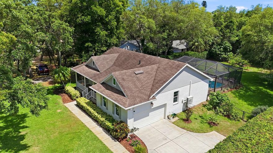 Welcome to your Dream Home! In the heart of Tarpon Springs and a walk to Sunset Beach this CUSTOM-BUILT coastal cottage is finally for sale! Built in 2014 with northern cottage charm in mind this house is truly one of a kind and you will be impressed in person! Quietly tucked away on an OVERSIZED 0.50-ACRE double lot, this exquisite property is MOVE-IN READY and has a SPECTACULAR LOCATION. Boasting 3 Bedroom + a flexible Bonus Room/Office/Den, 2.5 Bathrooms, an oversized 2 car garage designed with plenty of height for storage and two beautiful windows, a LARGE POOL with screened-in enclosure, a HUGE front yard, and a HUGE backyard that is totally private. This house is set back from the road behind beautiful oak trees, offering a serene retreat and total privacy. Many great features of this home include its elevation as it's ELEVATED AND HAS NEVER FLOODED, and the WINDOWS ARE ALL TRIPLE-PANE HURRICANE RATED. As you step onto the charming, big front porch you are greeted by an authentic northern cottage style. Step inside the foyer to find a very cute, light, and bright open-concept layout with high vaulted ceilings illuminated by natural light beaming from the skylights. The heart of the home is the open fully updated kitchen, featuring marble countertops, classic white kitchen cabinets, stainless steel appliances, a natural gas range, and a walk-in pantry closet. Enjoy meals in the cute, custom built-in breakfast nook with bench seating that includes storage underneath and a fantastic view of the pool and backyard. Designed as a split bedroom floor plan, the primary bedroom is located in the back right corner and features a walk-in closet with built-in shelving, and access to the pool. The primary bathroom is an en-suite fully updated with a glass door shower, a separate tub, and a dual vanity sink. The spare two bedrooms are located on the left-hand side of the house, both also featuring custom built-in shelving in the closets, and wonderful windows. The second full bathroom sits in the hallway between the two spare bedrooms and features an updated vanity and a tub/shower combo. The flexible bonus room makes for a perfect office or den, featuring a custom 9-foot cherry study workstation and custom built-in bookshelves. The half-bath offers direct access to the pool. Step outside to discover your own private, very quiet pool oasis. Entertainment is effortless in this big, screened-in pool enclosure featuring a 32-foot long pool (6 feet deep in the deep end), and spa. The huge backyard is fully fenced and offers plenty of space for pets and kids. The home has had only two owners since it was custom-built in 2014, with the current owners taking meticulous care of the property since 2018. Notable assets include durable ceramic tile flooring throughout the entire house, again all windows are triple-pane hurricane impact windows, a brand-new 2026 HVAC system with a 10-year transferable warranty, and a tankless water heater. This property truly has everything on your wish list and checks all of the boxes for a perfect primary or vacation house. There's no HOA. You are just a 5-minute walk to Sunset Beach, giving you quick access to a beach, playground, picnic tables, and a community boat launch. Imagine watching sunsets nightly! With close proximity to Fred Howard Park, the historic Tarpon Springs Sponge Docks, Dunedin, Clearwater Beach, Tampa, and Tampa International Airport. Don't miss this opportunity. Schedule your private showing today!