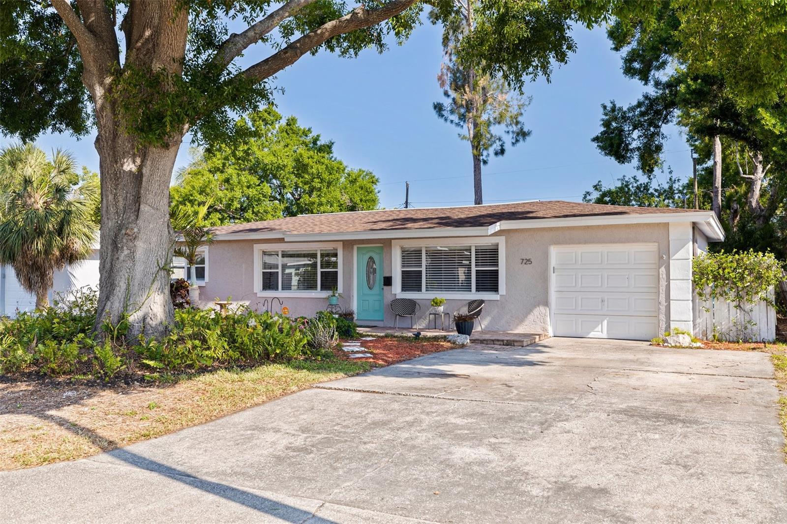 Nestled in a prime location, the property at 725 85th Avenue North offers a delightful blend of comfort and convenience. With 1,640 square feet of living space, this residence features a bright and airy interior, ideal for both relaxation and entertaining in a very convenient North St. Pete neighborhood! This spacious four-bedroom, two-bath home features a majestic oak in the front yard for cool shade and an oversized, fenced-in back yard. Newly polished, original terrazzo floors complement the front half of the home and light-toned, luxury vinyl plank flooring cover the large sunroom/family room and primary suite. This light-filled home offers a large kitchen with gleaming quartz counter-tops, solid wood cabinetry and a convenient breakfast bar with all stainless appliances. There is ample storage throughout and is ideal for hosting family and friends. The newly renovated primary suite includes a large walk-in closet and updated bathroom with a “barn-door” closure. Three additional bedrooms and updated guest bath round off this well-thought-out floor plan. Additional highlights of this beautiful home include a new roof (2022), contemporary, matching ceiling fans throughout and delightful covered front porch. The backyard also offers a patio for additional entertaining space as well as room to garden and enjoy the tropical green space. The driveway is complete with additional parking pad to enhance the many benefits of this move-in ready home. Nature enthusiasts will love the proximity to Weedon Island Preserve and the Gandy Bridge Beach areas. This attractive home is just 12 minutes to downtown St. Petersburg and very central for short drives to the gulf beaches, the St. Pete & Tampa airports, Tampa and Clearwater. This residence truly offers the best of St. Petersburg living!