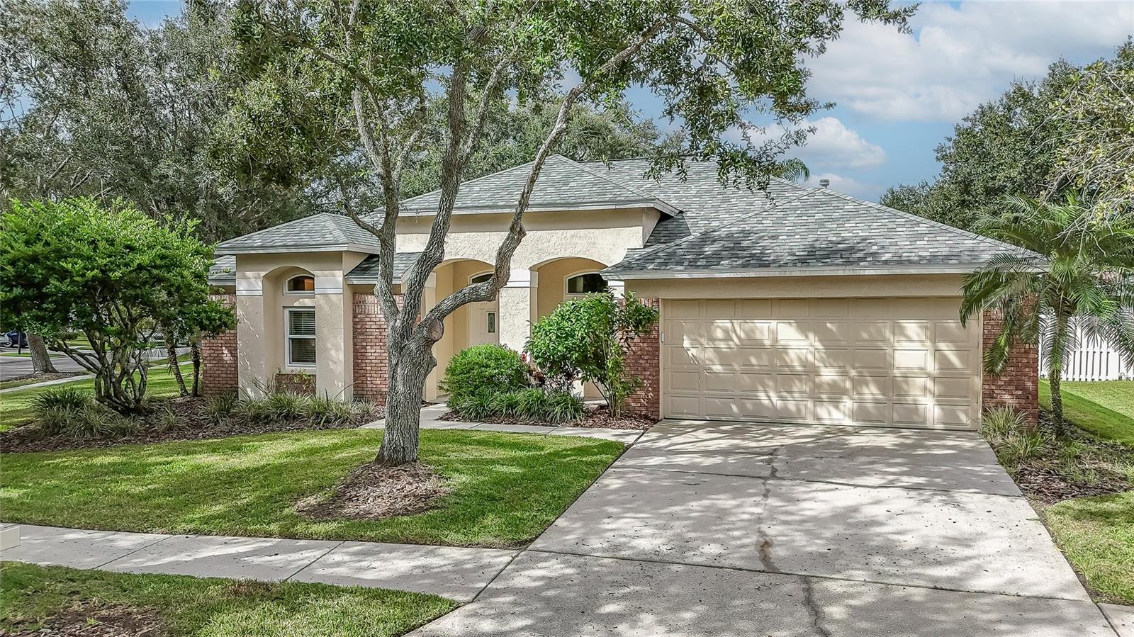 Welcome to Hunters Green, one of Tampa’s premier golf course communities featuring a 24-hour manned gate, tree-lined streets, and a peaceful, beautifully maintained setting that truly feels like home. This wonderful residence has had only one owner since it was built, and it shows in the pride of ownership and meticulous care throughout. Major updates bring peace of mind, including a new roof (2020) and all new windows (2019)—both adding long-term value, improved energy efficiency, and lower insurance costs. Offering a smart and spacious layout, this 4-bedroom, 3-bath home features both a living room and a family room, giving everyone plenty of space to spread out and gather—ideal for entertaining guests or simply enjoying time with family. The kitchen is perfect, complete with granite counters, beautiful wood cabinetry (some with elegant glass inlays), pull-out shelving, gas stove, a pantry, and a breakfast bar perfect for casual dining. A charming breakfast nook overlooks the family room, creating a warm and open flow that’s perfect for daily living. The fourth bedroom and guest bath are privately tucked away at the back of the home, offering wonderful privacy for visitors or family members. The primary suite is a relaxing retreat with two walk-in closets and an ensuite bath featuring dual separate vanities, a soaking tub, and a walk-in shower.
Three sliding glass doors—from the primary bedroom, living room, and kitchen—open to the screened lanai, where you can enjoy morning coffee or an evening cocktail while overlooking your spacious backyard. There’s plenty of room to garden, play, or simply unwind in the Florida sunshine. A separate laundry room with a washer and dryer included adds everyday convenience, while thoughtful design and care make this home truly move-in ready. Just a short stroll—less than two blocks—takes you to the community park with tennis courts, and the top-rated Hunters Green Elementary School is located right within the neighborhood. The location couldn’t be better, with quick access to major roads, USF, Moffitt Cancer Center, shopping, restaurants, and places of worship, all just minutes away. With its ideal floor plan and an unbeatable location in one of New Tampa’s most sought-after communities, this home offers the perfect combination of comfort, quality, and convenience. Don’t wait—schedule your private showing today!