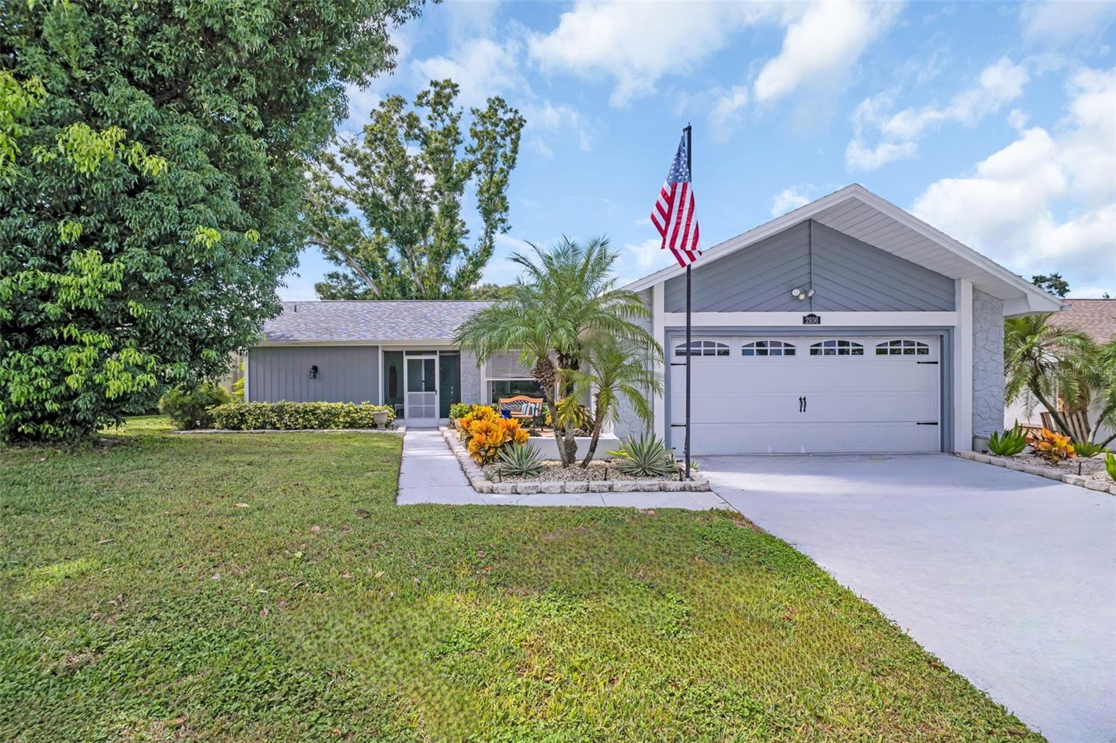 Welcome to this beautifully maintained 2-bedroom, 2-bathroom home with an office and over 1,700 square feet of open living space, nestled in Palm Harbor’s premier 55+ golf community—Highland Lakes! This thoughtfully designed home features a bright and airy split floor plan with expansive windows that flood the space with natural light. The centrally located kitchen is the heart of the home, boasting newer appliances, tray ceiling, a large cooking island, and a convenient pass-through to the sun-drenched Florida room—perfect for effortless entertaining. The spacious Florida room opens to a private backyard oasis with plenty of patio space ideal for outdoor dining, relaxing by a firepit, or grilling with friends. The luxurious master suite offers a large walk-in closet, additional built-in storage, a beautifully updated en-suite bath with a walk-in shower and rainfall shower head, plus an attached office space with endless possibilities. Enjoy peace of mind with major updates already done, including a NEW roof (2021), HVAC (2019), garage door (2021), and freshly painted exterior (2021). The home also recently passed a 4-point inspection, which is available for review and transferable to the buyer. Located high and dry in a non-evacuation zone, this home is truly move-in ready. Highland Lakes is renowned for its active country club lifestyle with a low monthly HOA of just $164, which includes FREE unlimited golf on three private executive courses, tennis, pickleball, bocce, shuffleboard, a dynamic clubhouse with regular events, fitness classes, and a lakeside lodge on Lake Tarpon with a private boat ramp, fishing pier, and community pontoon boats. There’s also free RV and boat storage, and the entire community is golf cart-friendly. Ideally situated near world-famous Gulf beaches, upscale dining and shopping, top-rated medical centers, major sports venues, two international airports, and a cruise port—this Highland Lakes gem blends elegance, comfort, and the ultimate Florida lifestyle. Don’t miss your chance to make it yours!