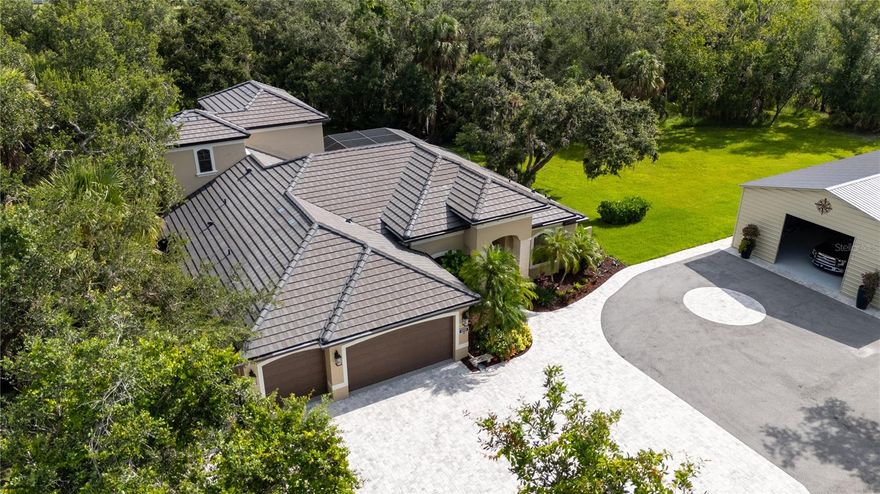 Rare Private Estate on 5+ Acres in Sarasota - A Magical Property Just 25 Minutes from Siesta Key. Opportunities like this are rarely available in sarasota area, where privacy, acreage and proximity to the beach seldom exist together. 

Welcome to 5850 Saddle Oak Trail, a beautifully remodeled all-block estate offering nearly 4,000 sq. ft. of living space on over 5 acres of extraordinary privacy within one of Sarasota’s most desirable gated communities. A long tropical Florida-style driveway welcomes you through lush landscaping, setting the tone for a property that feels both secluded and magical.

One of the most remarkable features of this estate is its private enchanted forest—a rare natural sanctuary on the property where winding pathways lead through mature trees and native foliage, creating a peaceful retreat ideal for meditation, nature walks, or simply enjoying the tranquility of your own woodland escape. This protected green space provides an unmatched sense of privacy rarely found so close to Sarasota.

Inside, the home features a spacious open floor plan with soaring tray ceilings, designed for both comfort and elegant entertaining. The fully renovated kitchen showcases modern cabinetry, quality finishes, and seamless flow into the living and dining areas. The residence includes 4 bedrooms, 4 updated bathrooms, two dedicated offices, and a versatile upstairs bonus space currently used as a media room, perfect for a gym, studio, or guest retreat.

Step outside to your private outdoor resort, where a beautifully renovated pool area awaits. Enjoy the heated pool and spa, expansive screened lanai, and elegant travertine decking, surrounded by lush tropical landscaping designed for year-round relaxation and entertaining.

For collectors, hobbyists, or those seeking additional space, the property includes two garages—a traditional attached garage and a newly built 1,500 sq. ft. detached garage with epoxy flooring, offering exceptional flexibility for cars, boats, RV storage, workshop space, or future lifestyle needs.

The acreage also offers ample room for gardens, fruit trees, small animals such as chickens, or additional hobby structures, making this property ideal for those seeking a private estate, mini-farm lifestyle, or peaceful retreat property while remaining conveniently close to Sarasota’s cultural amenities, dining, and beaches.

Additional highlights include:

• New roof (2022)

• New oversized steel building

• New kitchen cabinetry

• New flooring in all bedrooms

• Impact-rated patio doors

• Newly paved circular driveway with custom paver/asphalt design

• Large fenced pet area for dogs to roam safely

* New pool area featuring travertine tiles 
 
The location also provides access to excellent educational opportunities including Skye Ranch School, The Out-of-Door Academy, and the nationally recognized Pine View School.

Properties offering this level of privacy, acreage, and proximity to Sarasota’s beaches and lifestyle amenities are increasingly rare. Whether envisioned as a full-time residence, private retreat, or unique estate property, 5850 Saddle Oak Trail offers a one-of-a-kind opportunity to experience nature, space, and luxury in perfect balance.

Schedule your private showing today and experience the enchantment for yourself.