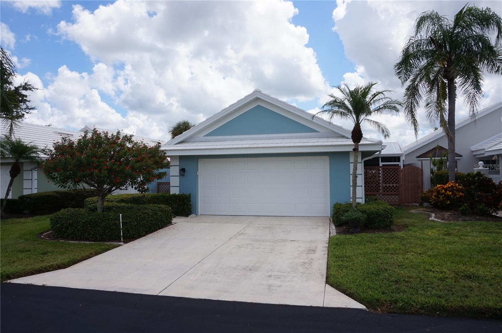 Welcome to this inviting residence in the highly sought-after community of Harrington Lake at Plantation Golf & Country Club. This spacious two-bedroom, two-bath villa with a two-car garage offers an ideal combination of comfort, convenience, and scenic views, making it a wonderful opportunity for year-round living or a seasonal retreat. Recent updates include a new roof in 2024, new ac in 2021, new water heater in 2025. As you step inside, you are welcomed by soaring cathedral ceilings that create an open and airy atmosphere. The main living areas feature durable laminate flooring that adds warmth and character, while the kitchen is finished with easy-to-maintain tile. Large windows allow natural light to flow throughout the home, enhancing its bright and welcoming appeal. The kitchen is designed with both functionality and style in mind. White cabinetry provides a crisp, clean backdrop, complemented by extensive countertop space that makes cooking and entertaining a breeze. The kitchen is equipped with a built-in wall oven and an electric cooktop situated on the island, offering convenience for meal preparation. In addition, there is a built-in desk, perfect for keeping organized, and plenty of room to accommodate a breakfast table. Whether you’re enjoying a casual meal or preparing for gatherings, this kitchen is well-suited for a variety of needs. The primary suite is a peaceful retreat, complete with a walk-in closet that provides ample storage. The primary bathroom features dual sinks, a soaking tub, and a separate walk-in shower, creating a private space for relaxation and comfort. The guest bedroom and second full bathroom are equally well-appointed, ensuring that family and visitors feel right at home. This residence offers multiple spaces to enjoy the Florida lifestyle. A Florida room provides additional living space under air with tranquil views of the pond, while the separate screened lanai allows for comfortable outdoor relaxation. From morning sunrises to evening sunsets, the setting offers a beautiful backdrop for daily living. The home is also topped with a tile roof, adding to its curb appeal and long-lasting durability. Harrington Lake is part of the master-planned Plantation Golf & Country Club, one of Venice’s premier communities known for its picturesque lakes, manicured grounds, and friendly atmosphere. Residents enjoy access to a community pool, social activities, and beautifully maintained common areas. Membership at Plantation Golf & Country Club is optional and offers a wide range of amenities, including championship golf courses, tennis, pickleball, fitness facilities, dining, and a full calendar of events. With its convenient location, the community is just minutes from shopping, dining, Gulf beaches, and all that Venice has to offer.