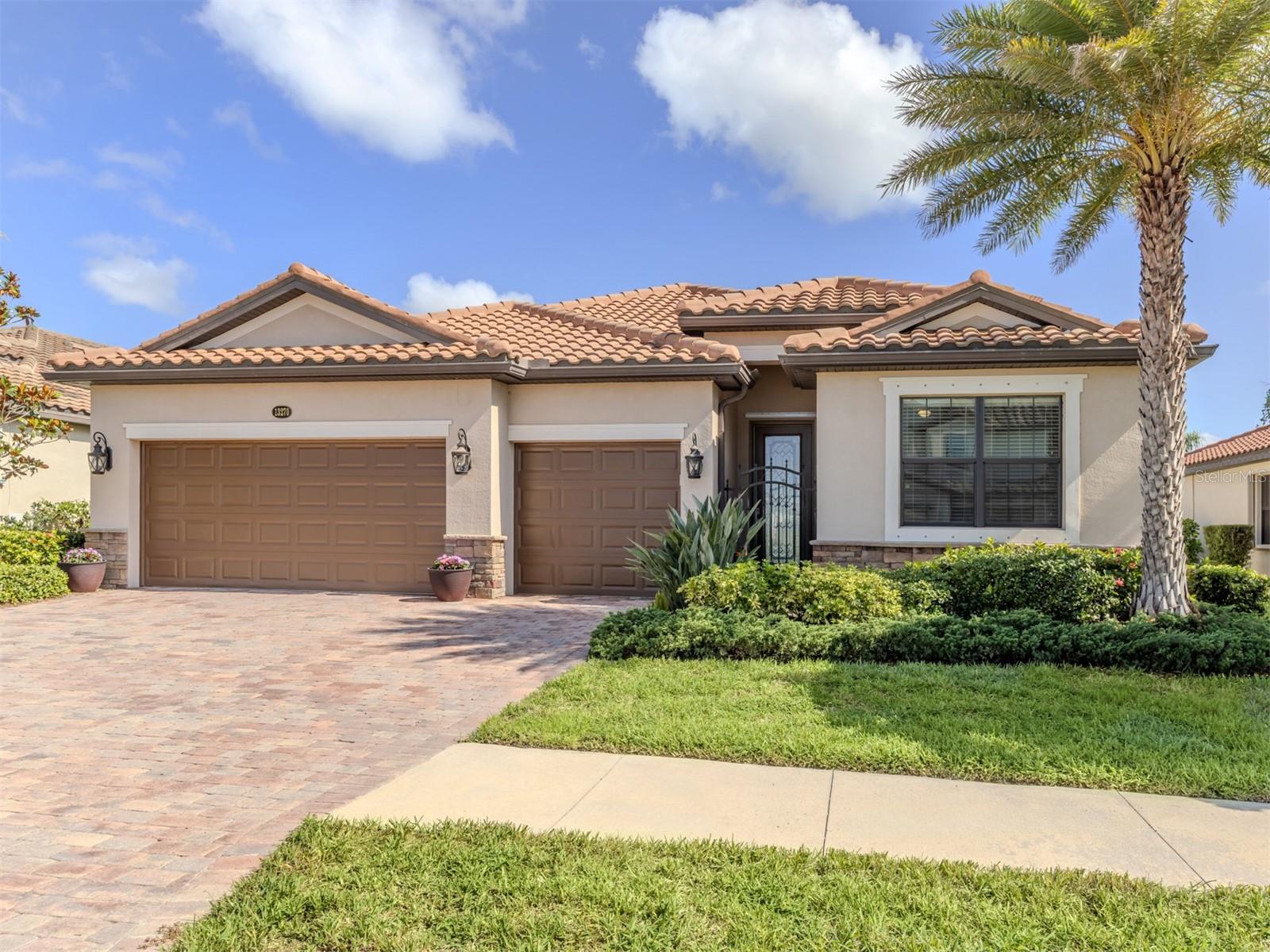 One or more photo(s) has been virtually staged. Welcome to 13270 Famiglia Drive, in the 24-hour gated Gran Paradiso community at Wellen Park. Spanning 2,254 square feet, this four-bedroom, three full-bath residence offers refined indoor-outdoor living and proximity to exceptional amenities. The oversized kitchen is appointed with stainless steel appliances, a large center island, and ample cabinet space—ideal for everyday living and entertaining. The primary suite includes an expansive walk-in closet and lovely lake view. A spacious, extended lanai showcases ultra-panoramic lake view panel screening, offering tranquil water views. For dog lovers, this home has been enhanced with a private fenced run and has a paver driveway leading to the three-car garage. Near the clubhouse, the residence is close to a direct pathway over a footbridge leading to all amenities the community has to offer. Community amenities include a resort-style pool and spa, fitness center with a separate studio for classes, sauna, massage services, tennis and basketball courts, playground, several rooms for card playing and special events and full-time activity director. Families will appreciate the location near a top-rated elementary school and a new technology-integrated high school slated to open for the 2025–2026 academic year. The Italian translation for Famiglia is family.