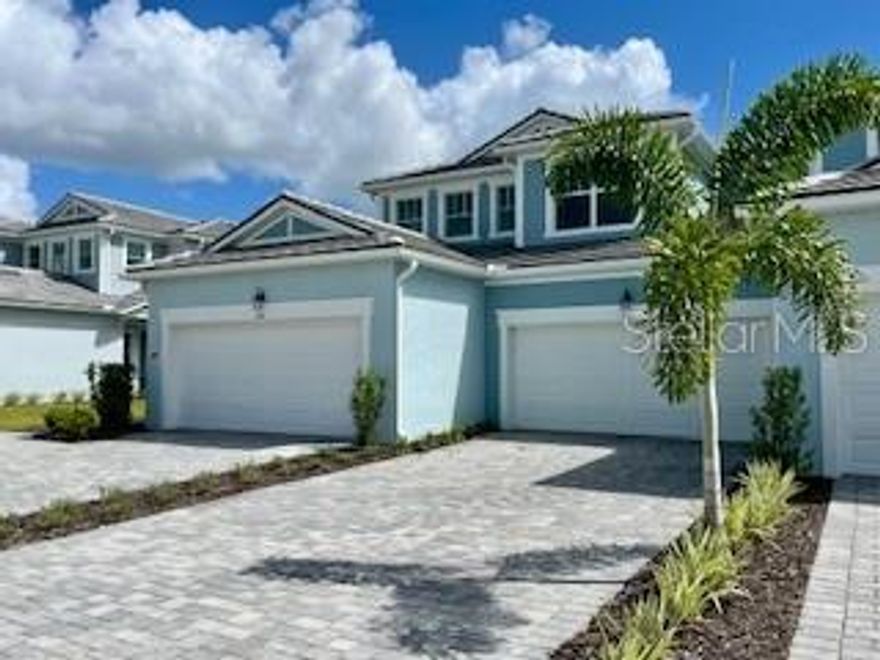 17390 MOONFLOWER Drive #101 Venice, FL 34293
The stunning Carmel II first-floor coach home located in the Lakespur community of Wellen Park. Walkable to the New High School scheduled to open 2026, it totals 1,406 sq. ft. of thoughtfully designed living space with 2 bedrooms, 2 full baths and 2 car garage. The open-concept floor plan creates an inviting flow, with a designated dining area seamlessly connecting the kitchen and great room. The upgraded Executive chef’s kitchen boasts modern designer finishes with Soapstone colored quartz countertops, an abundance of shaker style white cabinets, stainless-steel appliances, and an island breakfast bar that comfortably seats five. The unique white linear tile backsplash ties it together and the walk-in pantry adds extra storage. The spacious owner’s suite is a private retreat, featuring an en suite bath with a raised dual-sink vanity, oversized shower with a ledge, linen closet, and private water closet. The large walk-in closet offers shelving on three walls. The second bedroom and bath are situated on the opposite side of the home, providing privacy for guests. The screened balcony, accessible through stacking glass sliding doors, offers a perfect spot to enjoy the outdoors, gazing out over the conservation area. This home combines luxury, comfort, and functionality with elegant design touches throughout. Featuring Clare's Smart Home Technology package that connects to video doorbell, garage door and front door lock.
Perfect home for snowbirds who want to rent it out during the off season, you have that option here with minimum 30-day rental, 4 times per year!
***
Photos, renderings and plans are for illustrative purposes only and should never be relied upon and may vary from the actual home. Pricing, dimensions and features can change at any time without notice or obligation. The photos are from a furnished model home and not the home offered for sale.