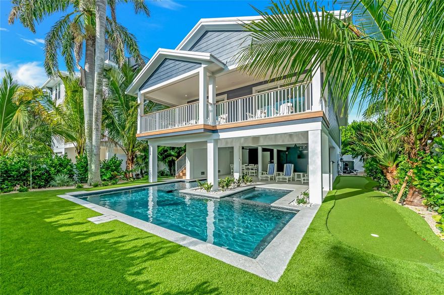 Beautifully renovated 3-bedroom, 3-bath home located in the heart of Bradenton Beach, offering a clean coastal design and highly functional layout. Updated throughout, the property presents a fresh, move-in ready feel with modern finishes and an open-concept living area designed for comfortable everyday living and entertaining.

Ideally positioned just one block from Anna Maria Sound and approximately four blocks to the Gulf beaches, the location provides convenient access to both bay and beach. Outdoor living is a key feature, with a private pool and spa, multiple balconies, and dedicated areas for lounging and dining in a tropical setting.

The elevated structure includes a two-car garage with alley access, along with established landscaping that enhances privacy and curb appeal. Inside, the single-level floor plan offers seamless flow between the kitchen, dining, and main living spaces. The kitchen is centrally located and well-suited for gathering and daily use.

All three bedrooms include ensuite bathrooms, each updated with contemporary finishes. Two bathrooms feature walk-in glass showers, while the third includes a tub and shower combination.

Conveniently located near local shops, dining, and waterfront activities, with access to the free island trolley for easy navigation throughout Anna Maria Island. This property offers a well-balanced combination of updated interior finishes, strong outdoor living, and a central island location.