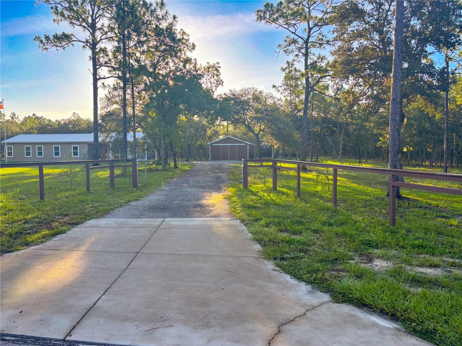 Experience peaceful country living with modern upgrades on this fully fenced 5.13-acre property in Lecanto! Built in 2021, this 2 bed, 2 bath home features granite countertops, 3-foot doors, and a handicap-accessible primary suite. The home offers a 1,060 sq ft layout with a screened patio (330 sq ft) and a 736 sq ft carport—both built to easily enclose for future living space with permitting. A detached, insulated 960 sq ft barn with a steel roof is ideal for a workshop, storage, or hobby area. Additional highlights include a new metal roof, full RV hookup with 50 amp electric, and a gated driveway. Plenty of room for animals, gardening, or simply enjoying wide open space.