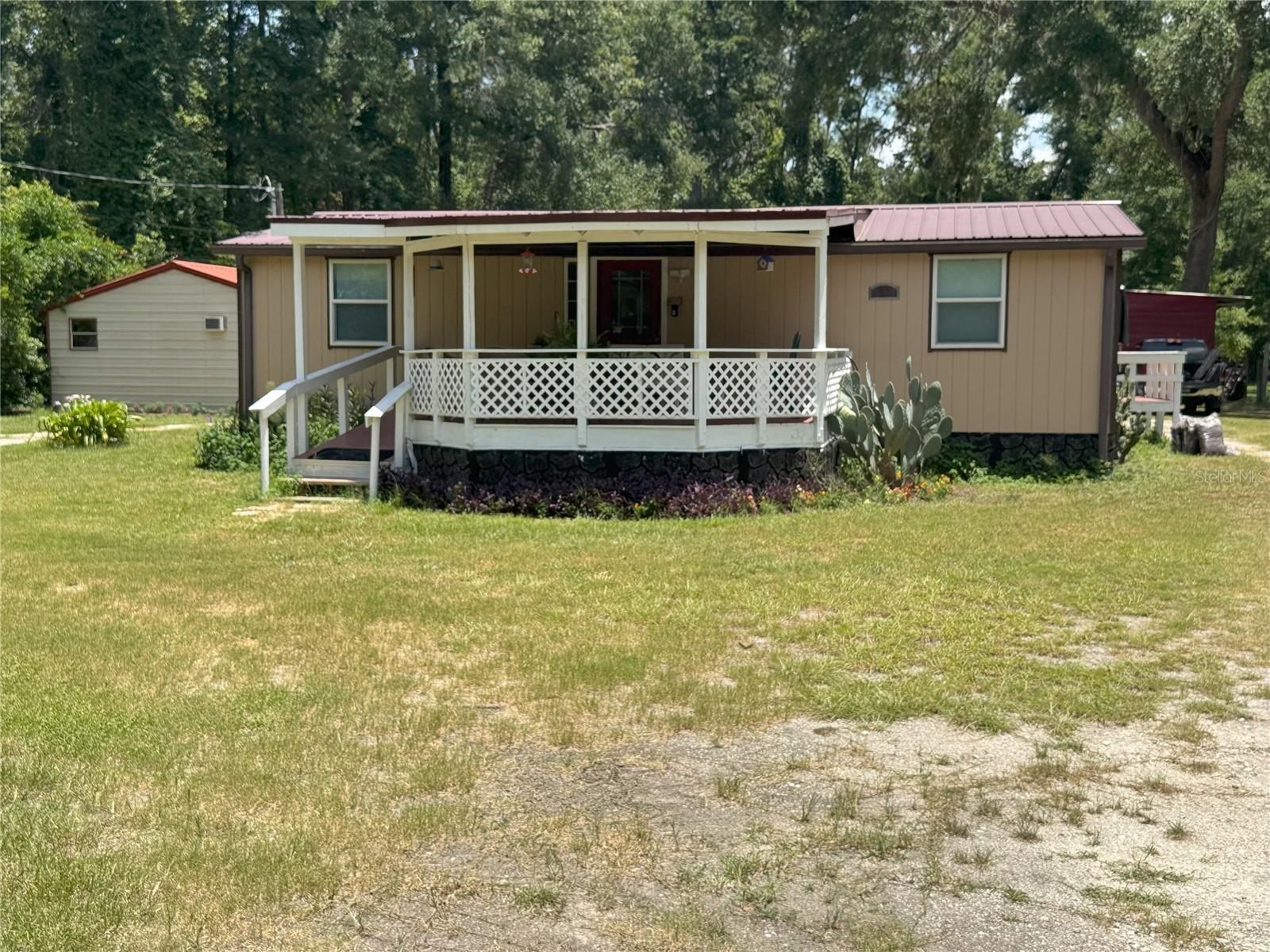 Dive into the serene countryside living with this stunning manufactured home! It boasts a spacious open floor plan, sleek laminate flooring, NO CARPET in sight and a gorgeous wood deck, perfect for morning coffee or relax after work, all nestled on a sprawling one-acre cleared lot. Features include a car port with separate storage space. Plus, there’s an electrifying 840 square foot insulated, climate-controlled workshop/auxiliary building to spark your creativity, with a convenient half bath.
All measurements are estimated; buyer and/or buyer's agent need to confirm all measurements.