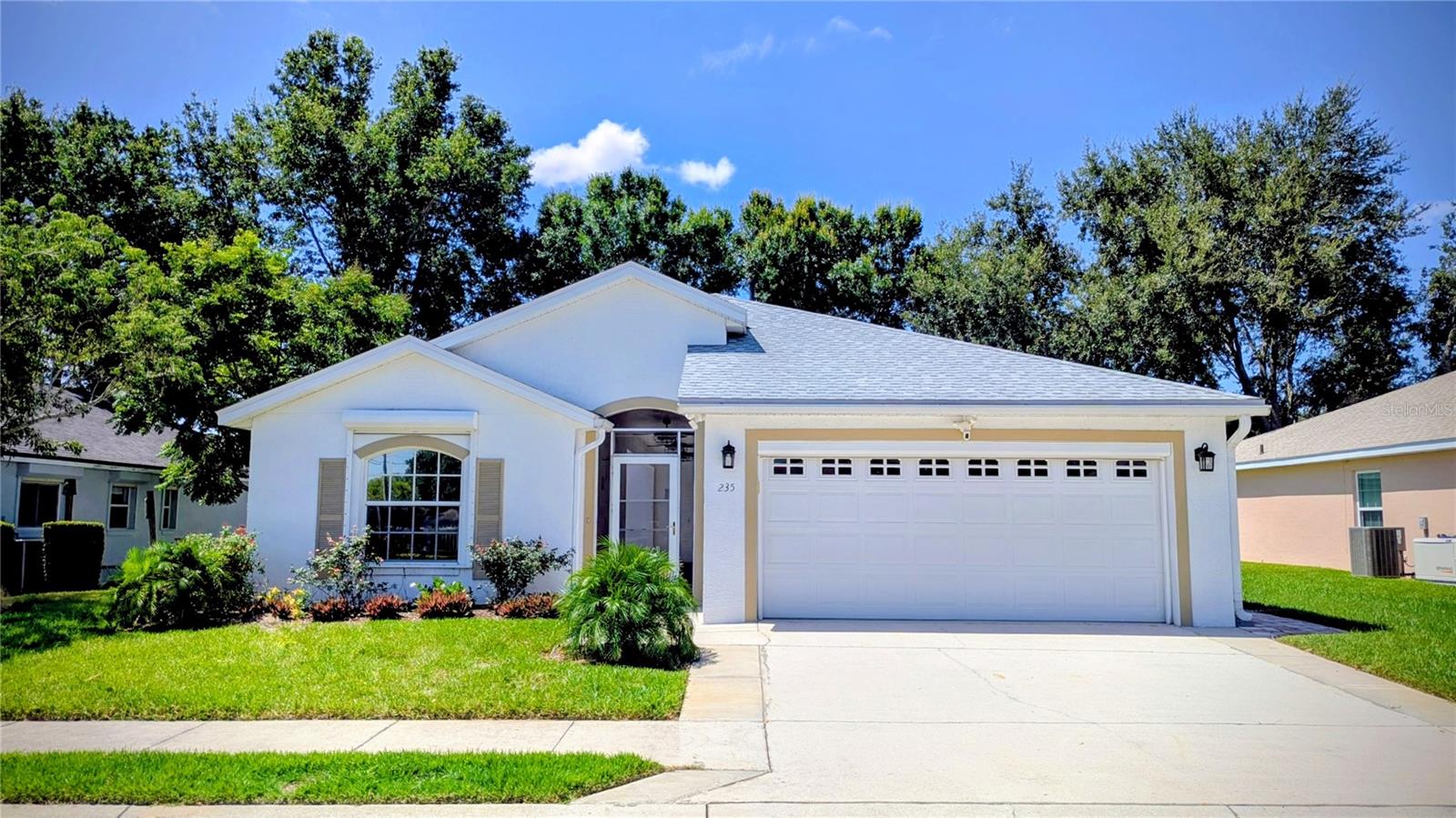 Welcome to this completely renovated retreat in a gated community of Chalet Estates! It isn't just another home in a 55+ community but two homes in one, connected by a dreamy screened breezeway that feels like something out of a magazine. The main 2 bedroom 2 bath house flows perfectly for your daily rhythm, while the separate guest suite with full bath and walk-in closet means spontaneous visits from guests never feel overwhelming. They have their space, you have yours, and everyone's happy and comfortable.
But here's where it gets really good. No detail has been missed here. New luxury vinyl plank flooring flows underfoot like silk. The kitchen is equipped with Quartz countertops, deep basin sink, and stainless steel appliances. The new roof installed in 2022 means no worries when storms roll through, and speaking of storms—hurricane shutters and a whole-home generator ensure your comfort never depends on the weather. The AC and gas water heater are only 3 years old. The Ring security system was installed with floodlights and cameras for your peace of mind. The expanded driveway and pavers create the perfect welcome for guests. Newer paint inside and out makes everything feel crisp and new.
And then there's Lake Suzanne herself. Your private fishing pier waits for quiet morning moments. The heated community pool beckons on lazy afternoons. The clubhouse hosts neighbors who've become friends, celebrating holidays and milestones together. The HOA handles every blade of grass, every community detail, leaving you free to enjoy life. Some photos were virtually staged. This is a must see!