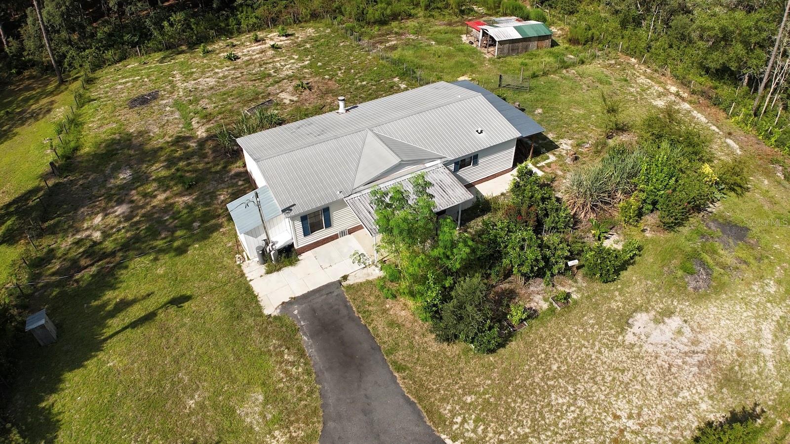 MINI-FARM - Private 1.25 Acre. Can easily be income producing. Close to the World Equestrian Center. This high and dry property is zoned agricultural. Nestled among mature wood trees, this beautifully fenced property has 3 Paddocks, Vegetable Garden with Orange & Grapefruit Trees. Charming 3-bedroom, 2-bath with fireplace, perfect for enjoying country living. Bring ALL your toys. Highlights include: Rainbow Springs & KP Hole Park, provides unlimited recreation. Perfect safe place for your family! Minutes to Juliette Falls Wold Class Gold Course, shopping, medical and fine dining options in historic Ocala, Gainesville & Dunnellon. Major highway access I-75, and more. Call NOW before it gone!