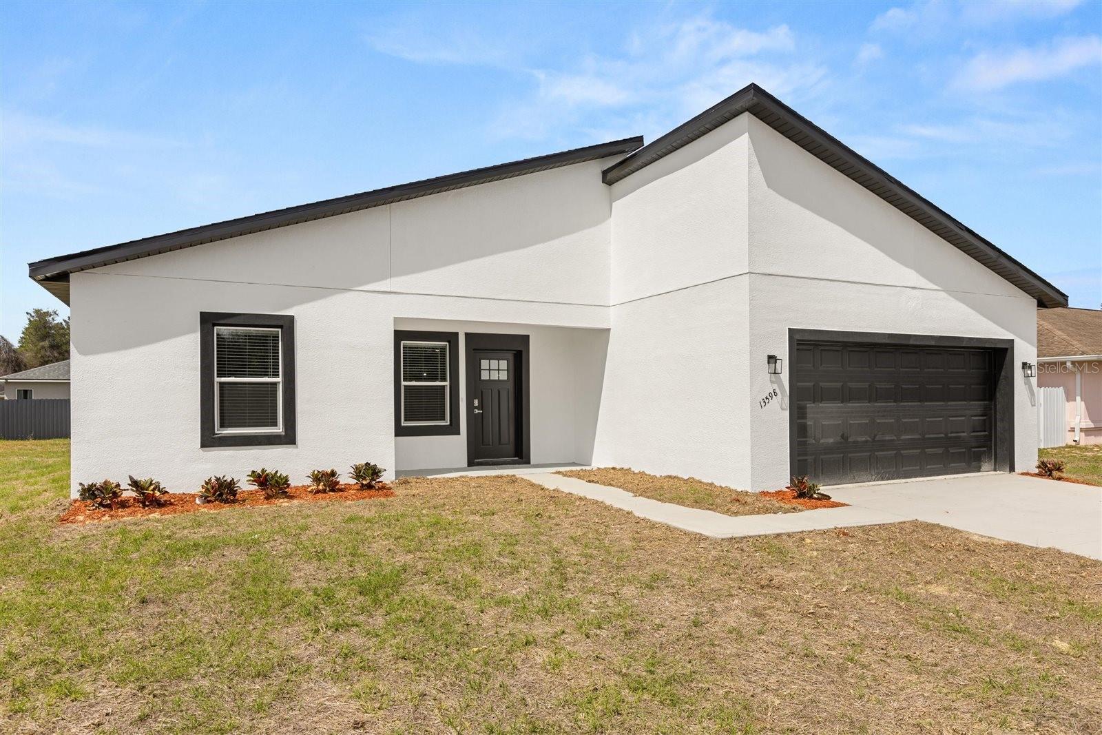 Space, style and a location you'll love at a great price point! Be the first to occupy this new 4/2 with 2-car garage, located on a circle in a quiet neighborhood. As you enter, you will notice that the high ceilings throughout lend to the open feel of the home. The kitchen offers generous lighting, granite counters, upgraded SS appliances and a pantry closet. There is luxury vinyl plank flooring throughout the home, except for the Primary Bathroom. The Primary Bath offers everything you could ask for: Separate room for water closet, a shower, separate soaking tub, higher double vanity with stone counter and lots of space. There are window treatments throughout the home as well. You will love the location of this home in Marion Oaks Unit 1. It is at the front of the subdivision, just two miles from I-75 and less than a mile to the new Aldi’s, only three minutes away! Marion County’s newest high school is under construction in Marion Oaks, just four miles away. All of this, and it is under a 1-year full Builder’s Warranty. Come see this beautiful home in a growing area. You will want to make it yours!