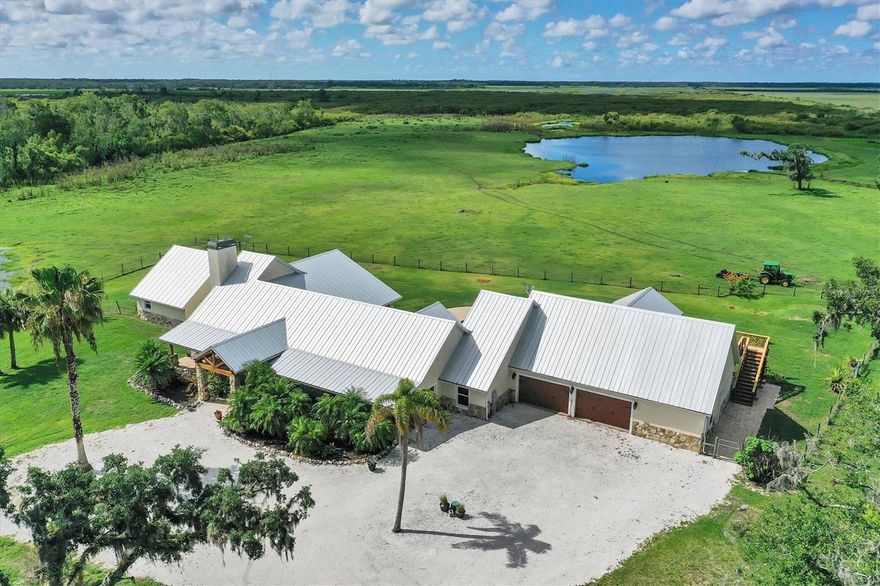 One or more photo(s) has been virtually staged. Huge Price Reduction on this beautiful home and property!  Come home to this beautiful custom home with a pool on 80 acres in highly sought after Myakka City. Two parcels make up this 80 acre property.  This home has 5 bedrooms, 6 baths and the Master Suite has an ensuite bath and your own private theatre/media room.  This block construction home has a metal roof that adds to the beauty of this home. Imagine the possibilities of entertaining family and friends with beautiful views and large pool.  The ensuite has two separate single sink vanities, two water closets, dual walk-in closets with combination locks and a wet bar. From this huge room, French doors open up to the patio and pool area.  Granite countertops in the kitchen and bathroom countertops. There is new paint throughout the home and new engineered hard wood flooring and carpet. The uniquely shaped pool measures 50' x 24' and there are outside hardwired speakers and a gas hookup for your grill in the patio area. The kitchen has granite countertops, a 40" high countertop island with 2 sinks, a stainless sink and also a  farmhouse apron sink, a six burner gas Wolf stove with griddle and hood, a stainless commercial refrigerator and plenty of room to entertain. The floors throughout the kitchen, dining and living area are engineered hardwood, newly installed.  The living room has a gas fireplace with tile trim.  Enjoy hours of family entertainment in the media/ theatre room on the second level with electric reclining chairs. Each bedroom has it's own bathroom and ceiling fans. The spacious laundry room has water hookup for an extra refrigerator.  Do you have family and friends wanting to visit from out of town? If so then this home comes with an interior studio apartment with small kitchen, bedroom and bath.  There is an additional full apartment on the second floor above the two car garage with kitchen, bedroom, and living room overlooking the pool from the newly updated deck/balcony. Don't miss the creek trickling on the west side of the yard.  The home is wired for surround sound.  There are 2 AC units for the main home and 1 unit for the upstairs apartment.  The master suite has a separate hot water heater and the other hot water heater for the home is in the garage.    There is electric and water hookup for your RV. There are 2 septic tanks, one for the  home and the 2nd for the upstairs apartment.  Also, a plug for a generator to power the house.  The back yard pool area has ample area for entertaining and enjoying beautiful views of the pasture and pond.   The front yard and drive is shaded with large oak trees. There are 3 chicken coops so bring your free range chickens. The pond in the back pasture is over 4 acres. The rear parcel stays wet most of the year.  There is a 300 yard shooting range at the rear of the parcel. This lovely home allows for great entertaining with it's large kitchen and spacious lanai and patio area at the pool.   This home and property has no deed restrictions so livestock are allowed and there are NO HOA FEES. There is an  automatic gate at the entrance.  There is a new golf community being planned now just 1.8 miles east of this lovely home on Singletary Road.  Only 15  driving miles to I-75 at Fruitville Rd. and 14 miles to Lakewood Ranch. Selling As Is with Right to Inspect.