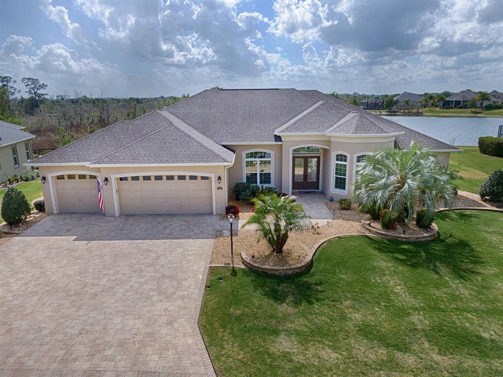 SPECTACULAR WATER and PRESERVE VIEW on this 4/3 GRANDVIEW PREMIER with EXPANDED 3 CAR GARAGE, AMAZING HEATED POOL w/WATERFALLS and FIREBOWLS LOCATED IN THE VILLAGE OF OSCEOLA HILLS AT SOARING EAGLE! LOVELY curb appeal with STACKED STONE CURBING, rock beds, palms and shrubs around the entire home! GORGEOUS entrance with double LEADED GLASS FRONT doors which open into the grand foyer where you will find the formal living room and separate formal dining room! TILE flooring flows throughout the entire living area and there is CROWN MOLDING throughout the entire home! Between the living and dining room towards the kitchen, you'll love the convenient butler's pantry and wine/beverage bar! The spacious kitchen has LOVELY STAIR-STEP CHERRY CABINETS, GRANITE counter tops, subway tile backsplash, STAINLESS appliances with bottom freezer refrigerator and built-in smooth top range (gas is available)! There are POT DRAWERS, pull-out drawers, large CLOSET PANTRY, an island with electrical outlets, extra storage with PENDANT lighting and a large breakfast bar with diagonal tile frontage! The FAMILY ROOM has sliding glass doors that open to the AMAZING POOL AREA or inside you can just enjoy the VIEW! The 3rd bathroom has access from the family room for your guests and also works well as your pool bath! There is a pocket door that leads to the guest suite with 2 guest rooms and guest bath! All bedrooms have carpet flooring and spacious closets! The guest bath has GRANITE counter tops and lovely tiled shower/tub! The 3rd guest room is being used as an office! The generous master suite has a tray ceiling, access to the POOL area, 2 large WALK-IN CLOSETS and an EN-SUITE MASTER BATH! The master bath has dual sinks with 2 separate counters with GRANITE, a linen closet, lovely tiled ROMAN SHOWER and separate toilet room! The laundry room has a built-in sink, cabinets, and FRONTLOAD washer and dryer that do convey with the home! YOU'LL LOVE THE OVERSIZED 3 CAR GARAGE! Epoxy flooring, and MAJIC STAIRS for access to the floored attic with lots of storage space! BUT JUST WAIT UNTIL YOU STEP OUTSIDE TO THE MAGNIFICENT COLUMNED BIRDCAGE POOL AREA WITH A GORGEOUS VIEW OF THE LAKE AND PRESERVE! The SUMMER KITCHEN is a great addition for everyday and/or entertaining use! YOUR OWN PRIVATE RESORT with SPECTACULAR SUNSETS, WATERFALLS and FIREBOWLS at night! This is AN AMAZING HOME in an ALL PREMIER VILLAGE in a great location!