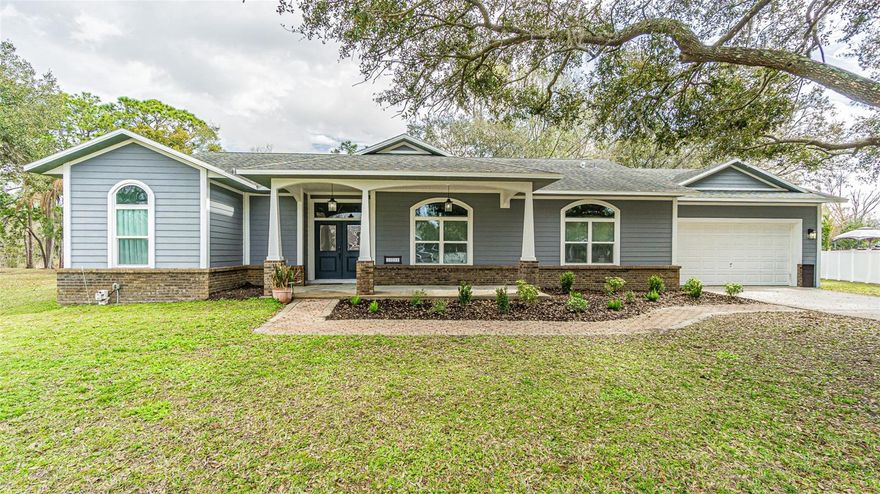 These unique custom homes rarely come available. Completely renovated with no expense spared, this stunning 3-bedroom, 2-bath heated pool home offers exceptional design, quality craftsmanship, and nearly half an acre of serene conservation views. Located off Hwy 301 just minutes from USF, this property sits on a quiet cul-de-sac surrounded by mature oak trees in a semi-secluded neighborhood with no HOA. A 10’ x 24’ open front porch and 6’ wide double entry doors welcome you into an impressive foyer that opens to a spacious great room featuring a wood-burning fireplace, soaring 10’ ceilings, and beautiful tile flooring throughout. The fully remodeled kitchen is the centerpiece of the home, showcasing custom 40” and 48” glazed cabinets with crown molding, 21 soft-close drawers (including 6 extra-wide), granite countertops, under-cabinet lighting, marble backsplash, and a massive 4’ x 8’ granite island with single-bowl stainless sink and dishwasher. Additional highlights include a coffee/server bar with wine refrigerator, glass display cabinets, breakfast nook cabinetry with pop-up outlets, stainless steel appliances, dual ice maker refrigerator, convection microwave, and dual-temperature oven. A large pantry provides even more storage. The primary suite is generously sized with French doors leading to the screened lanai, oversized walk-in his-and-her closets, and a beautifully remodeled bath featuring granite counters, high-profile cabinetry, and upgraded fixtures. The guest bedrooms are spacious, including a built-in desk in one of the closets and a pool-access bath with matching granite counters and tub/shower combination. Custom touches throughout include ceiling medallions, tray ceiling with inlay in the dining room, wood window and door casings, elegant lighting fixtures, tiled shower accents with niches, and coordinated finishes across kitchen and baths. Step outside through the 2nd set of French doors to the covered, screened lanai overlooking peaceful conservation views and the heated pool—perfect for relaxing or entertaining. Additional features include: Extra-wide and extra-deep 2-car garage (29’ deep x 21’ wide) with 11’ ceiling, epoxy floor, space for workbenches that gives you plenty of room for storage. Wired for portable generator. Rear garage access door. Water treatment system with softener, ionizer, and pH filters. Upgraded vinyl front windows. Hardie board siding. Attic exhaust fan for energy efficiency keeping the home cooler. Full house alarm system with glass break, motion, and hardwired smoke detectors. Interior laundry room with upper cabinets and utility sink. This custom-built home offers larger-than-typical room sizes, abundant storage, and high-end finishes throughout. A true pride-of-ownership property designed for comfort, entertaining, and lasting value. Schedule your showing today.