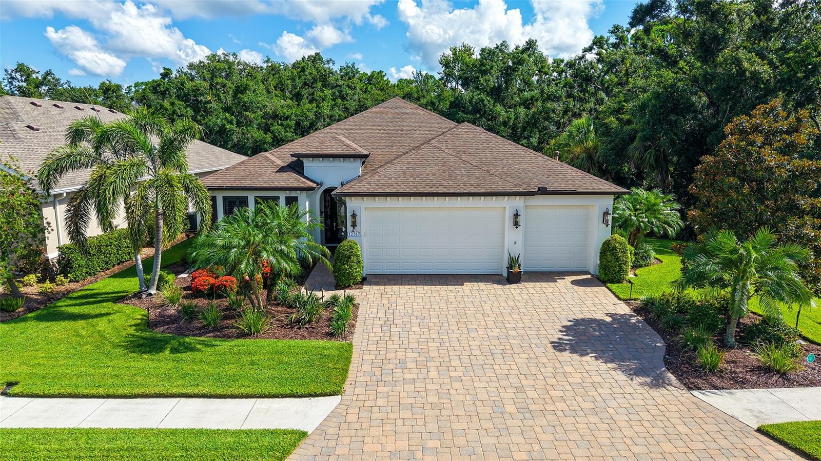 Welcome to perfection in Greyhawk Landing! This breathtaking, meticulously maintained 3-bedroom, 2-bath home with an additional office/den is truly a sanctuary; offering the ultimate in Florida living. From the moment you arrive, you'll be captivated by the lush, upgraded landscaping, elegant curb appeal, and welcoming façade. Step inside, and prepare to be wowed; the open, airy layout, soaring ceilings, and luxurious upgrades create an immediate “wow” factor that only gets better from room to room. Every inch of this home has been thoughtfully designed and lovingly cared for. Featuring tile flooring throughout the main living areas, exquisite light fixtures and fans, stunning coffered ceilings, 8-foot doors, and plantation shutters throughout, no detail has been overlooked. The chef’s kitchen is a true showstopper with GE Café appliances, granite countertops, an enormous center island, expanded cabinetry and storage, a built-in oven, a beautiful gas range, and a wine refrigerator; perfect for entertaining or everyday living. The guest bedrooms are spacious and private, making them ideal for family members or visiting guests. The flexible den/office is a dream space; perfect for working from home, studying, or transforming into a playroom, man cave, or even a cozy she-shed retreat. The oversized laundry room is another fantastic feature, offering plenty of space, storage, and function; a true bonus in a home that already has it all. Retreat to the spa-like primary suite, designed with luxury and serenity in mind. The en-suite bath is simply magnificent, offering high-end finishes and an atmosphere that feels like a private resort. All bathrooms and the kitchen have been remodeled with tasteful, timeless elegance. Step outside into your private outdoor oasis, where a saltwater pool with waterfall feature, full landscape lighting, and peaceful preserve views creates the ideal backdrop for relaxation or entertaining. With no rear neighbors and no neighbors on one side due to the preserve, you’ll enjoy daily wildlife sightings and exceptional privacy. Hurricane protection? Absolutely; with electrical hurricane shutters and hurricane screens, this home provides true peace of mind. Additional highlights include a 3-car garage with epoxy flooring, natural gas appliances, and ample storage throughout. Located in the highly sought-after gated community of Greyhawk Landing, residents enjoy resort-style amenities including two resort-style pools with splash pad, a fitness center, clubhouse with social events, tennis and pickleball courts, basketball courts, two playgrounds, soccer and baseball fields, miles of walking/biking trails, lakes, a fishing dock, and a dog park; all for only $70/year in HOA fees! Just minutes from Lakewood Ranch, downtown Sarasota, SRQ Airport, I-75, and the world-famous beaches of the Gulf Coast, this home offers the perfect blend of luxury, comfort, convenience, and lifestyle. This is more than a home; it’s a lifestyle. A rare opportunity to own a slice of paradise in one of the area’s most desirable communities. Schedule your private tour today before it’s gone!