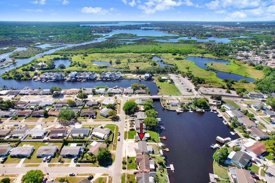 One or more photo(s) has been virtually staged. Experience the best of coastal Florida living in this updated WATERFRONT HOME, offering Gulf access via the scenic Anclote River. Set on a quiet street in Forest Hills in Holiday Florida, this move-in-ready residence blends contemporary comfort with timeless waterfront charm. This property has been thoughtfully renewed to deliver a home that looks and feels brand new. Step inside and discover a bright, open layout with luxury vinyl plank flooring, fresh interior and exterior paint, and sleek finishes throughout. The modern kitchen impresses with Quartz countertops, custom cabinetry, designer backsplash, closet pantry, and new premium stainless-steel appliances. A breakfast bar opens to the living area, while a pass-through window connects to the waterfront sunroom—ideal for entertaining or relaxing with scenic canal views and breathtaking sunsets. The adjoining breakfast nook/eat-in area adds the perfect spot to enjoy morning coffee while taking in the tranquil waterfront setting. The newly updated bathroom features quartz surfaces, upgraded fixtures, and a large glass-enclosed walk-in shower accented in gold tones. Both bedrooms are light filled with mirrored closets and remote-controlled ceiling fans, creating inviting, restful retreats. Outside, enjoy 63 feet of water frontage with a new floating dock and your very own private boat ramp, providing effortless access to the open Gulf of America. The property’s landscaping and easy-care rock accents enhance both curb appeal and low-maintenance living. Whether you’re boating, kayaking, or savoring sunset views from your own backyard, this setting captures the essence of Florida’s coastal lifestyle. Significant updates include a new roof, updated electrical panel, water heater, and a recent HVAC system. Additional features include a 1-car garage with laundry connections, covered front porch with stylish wood columns, and contemporary lighting throughout. There is no HOA, giving you freedom and flexibility of ownership. The location is convenient to shopping, dining, schools, medical facilities, and Gulf Coast beaches, with Tampa International Airport within close proximity—making it a practical choice for year-round living, a second home, or a high-demand investment property. Move-in ready, modern, and ideally positioned on the water, this residence offers the rare opportunity to enjoy a freshly updated home with true Gulf access at an exceptional value. Schedule your private showing today and experience the comfort, convenience, and lifestyle that make 1305 Basswood Drive such a standout along Florida’s beautiful west coast.