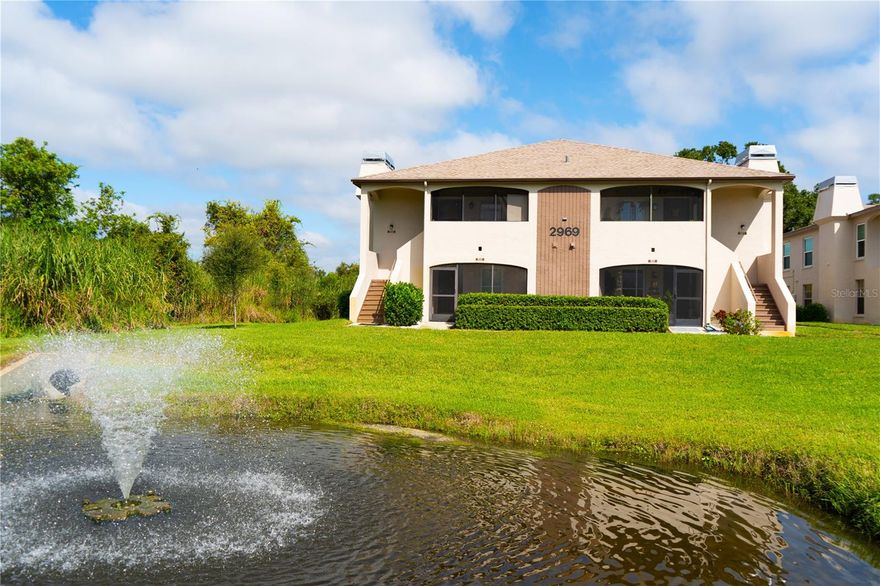 Attention VA Buyers...Charming First-Floor Corner Unit in Palm Harbor. All ages welcome and a pet friendly community with a LOW HOA.  Nestled in a serene, private wooded area, this beautifully renovated first-floor corner unit offers an idyllic retreat in Palm Harbor. The peaceful setting invites you to unwind and relax on your covered screen porch, overlooking a tranquil natural backdrop. Step inside to discover stylish, wide-plank wood-look ceramic tile flooring throughout the home. The updated kitchen is a chef’s dream, featuring crisp white shaker cabinets, sleek stainless steel appliances, sparkling granite countertops, a lovely light green subway tile backsplash, and modern hardware. The kitchen also boasts a convenient breakfast bar, perfect for four guests, and a separate dining area for intimate meals. The two-way split floor plan ensures privacy and creates an open, airy atmosphere that feels much larger in person. The spacious primary bedroom accommodates a king-sized bed and offers a generous walk-in closet with custom closet systems. The en-suite bathroom adds to the luxurious feel, providing a peaceful sanctuary. Additional highlights include a cozy wood-burning fireplace in the family room, 5 1/4-inch baseboards, crown molding, and no popcorn ceilings. For convenience, there are cordless blinds, soft window treatments, and dimmer switches throughout the home. A full-sized washer and dryer are tucked away in the screened lanai closet for added ease. The community offers a range of amenities, including a sparkling pool, hot tub, fitness center, sauna, clubhouse, and dog park. Active residents will enjoy the nearby bike trail, and the location is just a short drive to movie theaters, restaurants, and shopping malls. This pet-friendly community welcomes all ages with a low HOA fee. Furnishings are optional for the new owner, making this home move-in ready. Don’t miss your opportunity to own this beautiful, updated home in a prime Palm Harbor location!