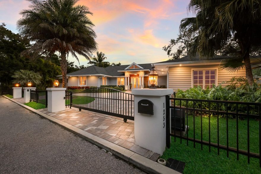 One or more photo(s) has been virtually staged. This exquisitely reimagined waterfront estate embodies modern luxury and serene exclusivity, offering 174 feet of prime waterfrontage in the prestigious Sanderling Club on Siesta Key. On a lush, nearly half-acre parcel, the residence enjoys a southern orientation, where panoramic views of a bridgeless bay unfold through walls of glass. A backdrop of meticulously landscaped greenery ensures privacy, all just near the water’s edge. At the heart of the home lies a state-of-the-art culinary haven. The chef’s kitchen is equipped with premium Wolf and Sub-Zero appliances, including a gas range and integrated espresso system, set within rich Merillat solid-wood cabinetry and dual islands designed for function and entertaining. Flowing seamlessly into the sunlit living and dining areas, the open-plan design creates an effortless connection between indoors and out. The living space extends gracefully to a sophisticated entertainment patio, where a firelit lounge, sparkling pool and fully appointed outdoor kitchen echo the refinement found within. The primary suite offers a tranquil retreat, framed by a garden and oak vista, and complemented by a spa-inspired bath featuring a deep soaking tub, dual vanities, and indoor and outdoor showers. An adjoining office doubles as a guest suite, while additional en-suite accommodations ensure privacy and comfort for visitors. Modern conveniences and peace of mind abound such as remote-controlled wrought-iron gates, impact-resistant windows and doors, whole-house water treatment, advanced smart-home systems, new roof, backup generator and environmentally conscious amenities, including a 500-gallon propane supply and integrated mosquito-repellent system. As a resident of Sanderling Club, you’ll enjoy access to a private beach, boat slips, tennis courts, clubhouse and 24-hour security, an unrivaled blend of leisure, privacy and coastal sophistication. This residence has been meticulously curated for those who seek the ultimate fusion of luxury and tranquility, an invitation to a lifestyle defined by elegance, ease and timeless waterfront living.