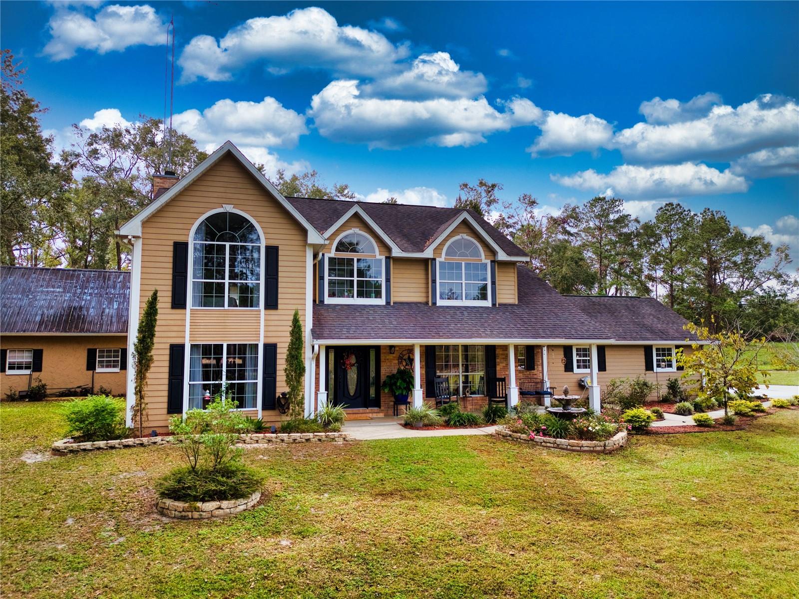 Welcome to Your Private Retreat on 4.79 Acres where Country Charm Meets Resort-Style Living! Discover the perfect blend of comfort, space, and functionality in this stunning 4-bedroom, 2.5-bath home nestled in one of the area's most desirable neighborhoods. Ideally located just minutes from town, you'll enjoy the peace and privacy of rural living with the convenience of city amenities close by. Step into an inviting home designed for both everyday living and entertaining. The spacious layout offers ample natural light and flows effortlessly into the backyard oasis. Enjoy year-round outdoor living with a resort-style pool, expansive covered patio, and cozy fire pit, all surrounded by mature trees and wide-open skies. Bonus alert! The detached pool house has been fully remodeled into a luxurious guest suite, boasting over 960 sq. ft. of private living space complete with an upstairs game room perfect for visiting family, in-laws, or even potential rental income. Need room for hobbies, a home business, or serious storage? This property delivers with a 30x60 workshop, featuring: An 80-gallon air compressor, fully piped for both air and water. Two enclosed bays for secure storage or workspace. Three additional covered bays for equipment, trailers, or extra vehicles. Asphalted driveway and workshop area for clean, durable access. With nearly 5 acres of gently rolling land, this property offers space to breathe, entertain, and grow.