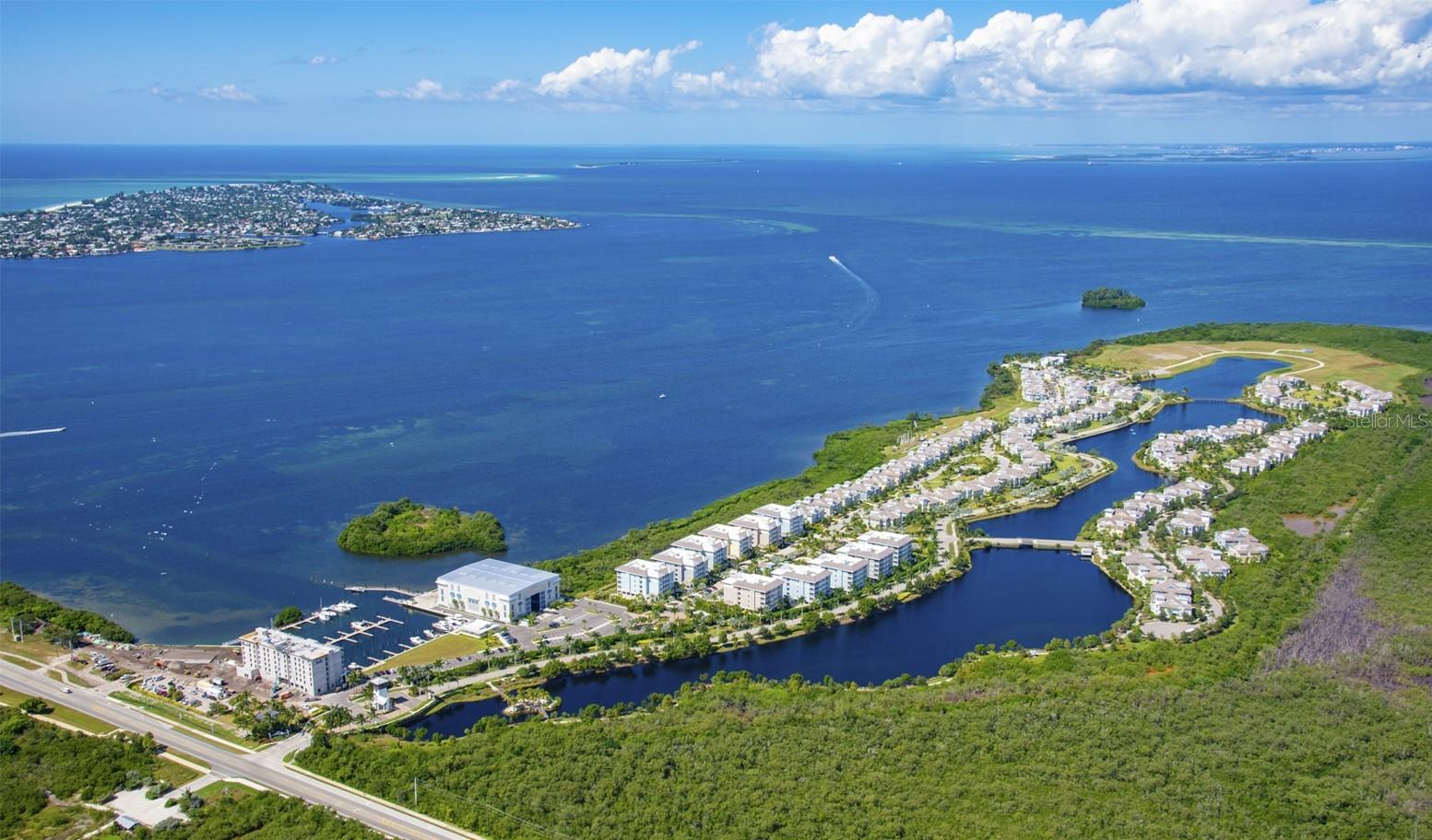 This corner-unit residence is truly one-of-a-kind. Perfectly positioned in an outside building, it offers sweeping, unobstructed views down the length of the lagoon and an unparalleled sense of privacy. Imagine waking up to sunrises shimmering across the water and unwinding to the sound of palms swaying in the breeze while enjoying morning coffee on your expansive lanai.
Inside, you’ll find 3 bedrooms and 3 baths, beautifully decorated and offered turnkey furnished. From the moment you enter, the wall of glass sliders draws your eye to the sparkling water beyond. High ceilings and an open floorplan create a spacious, airy feel that lives much larger than its square footage. Elegant yet comfortable décor provides the perfect setting for hosting guests, watching the big game, or simply relaxing. And while every detail inside is stunning, the lanai may just become your favorite spot—you’ll never want to leave those views.
Set within One Particular Harbour at Harbour Isle, this award-winning, gated community is designed for luxurious coastal living along the shores of Anna Maria Sound. Located less than a mile from the sugar-white sands of Anna Maria Island and the Gulf of Mexico, residents enjoy a lifestyle that is both vibrant and serene.
Community amenities are second to none:
• 4 resort-style pools
• Private Beach Club with its own beach & Sky Bar
• Onsite Marina with wet and Dry Slips
• 2 kayak launches
• State-of-the-art fitness center
• Miles of scenic walking trails with swings, hammocks, and Adirondack chairs
• Floridays Restaurant & Compass Bar and Chill
Whether you’re seeking peace and quiet or a social, amenity-rich lifestyle, Harbour Isle strikes the perfect balance.
For second home seekers or investors, those looking to offset ownership costs, the condos allow short-term rentals, and this residence has been a lovingly maintained second home with strong rental potential (rental data available). HOA dues include exterior maintenance and insurance (wind, flood, rain & hail), landscaping, pest control, cable/internet, virtually guarded gates, abundant amenities, and onsite community management—making ownership simple and stress-free.
With proximity to Anna Maria Island, Robinson Preserve, and endless coastal adventures, plus the security of newer construction built to the highest hurricane standards, this property is ideal as a full-time residence, vacation retreat, or investment opportunity.
If you’re ready for an effortless, lock-and-go lifestyle where every day feels like vacation, this is the one. Schedule your private showing and community tour today—your waterfront paradise awaits.
