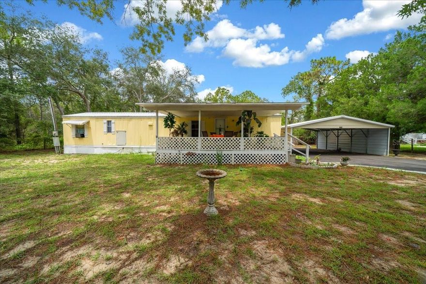 One or more photo(s) has been virtually staged. Welcome to this charming 2-bedroom, 1.5-bath single wide bursting with Florida character! Featuring a brand-new roof in 2025 & also a new refrigerator. This cheerful yellow home sits on a large lot with plenty of space to add your dream pool. Great for full-time living or a relaxing getaway, it offers an inviting front porch for morning coffee and a back porch with an oversized deck for entertaining or enjoying the sunshine. Laundry hook-ups are conveniently located on the back porch for easy access. The spacious yard provides endless possibilities—create a garden, add a pool, or simply enjoy the open space. Located just minutes from Homosassa’s waterfront, dining, and shopping, this home perfectly combines comfort, charm, and a prime location!