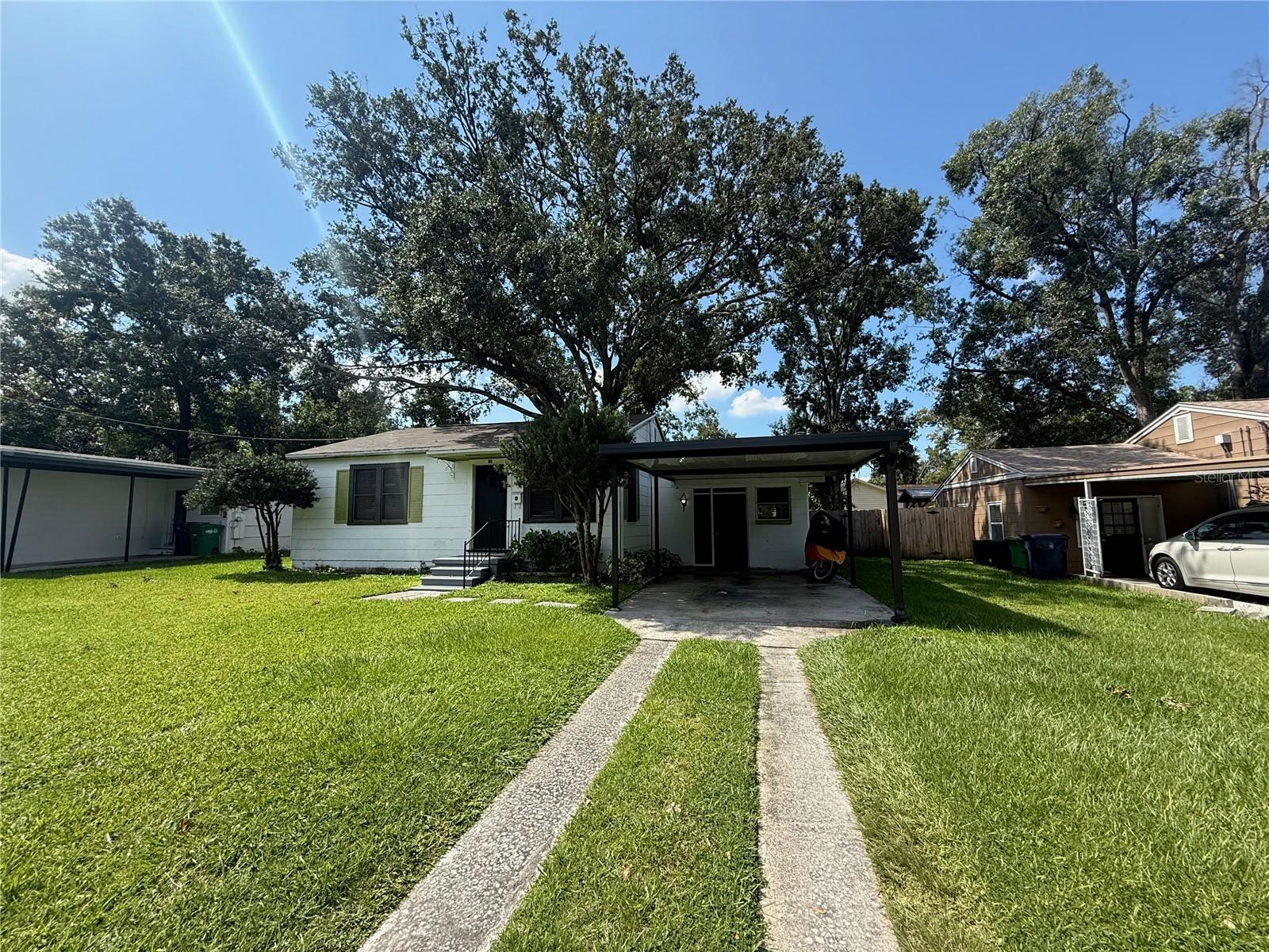 LOCATION!! This gem is in the heart of Tampa, minutes from interstates, downtown, airport, shopping, restaurants, and more...not to mention minutes to the Riverwalk! And yet, the backyard is a huge, private oasis perfect for relaxing, entertaining, and more. This is a one-of-a-kind opportunity to buy a turn-key, fully updated home with everything one could want. This home has been meticulously updated (all systems are 2023 or newer), and the tenants have added to the care and upgrading, too. There is an entry off the new carport that leads into a lower-level room that could be used as a third bedroom, office, or den. The laundry room and access to the back are off the rear of this room. Up a few stairs, the entire house has been redone. The kitchen has been completely remodeled with all-new appliances and thoughtful features. Plenty of counter and cabinet space for a true chef! The kitchen overlooks a large living room with large windows that let in plenty of light. The hallway leads to a remodeled bathroom with tiled cut-ins, fresh paint, and more. Two large bedrooms mean either one or both can be a primary suite. The tenants have positioned IKEA cube storage to create a wall in one room to separate it into a true wardrobe suite. Both rooms have large closets, more windows for light, but a sense of tranquility, perfect for rest. While the interior of the house is wonderful in its own right, the exterior is truly what separates this property from others. The backyard is HUGE, fenced, and ready for anything you want. Plenty of room to add a pool. A large raised deck is perfect for entertaining. A large wood shed is in line with the 8ft gate in the fence to store a RV, boat, or trailer. The back fence is lined with vegetation and producing banana plants. The entire backyard is wrapped around a huge oak tree that provides shade (and helps keep the electric bill in the house down, too). Mature landscaping means tons of privacy. Don't miss the chance to own this urban oasis!