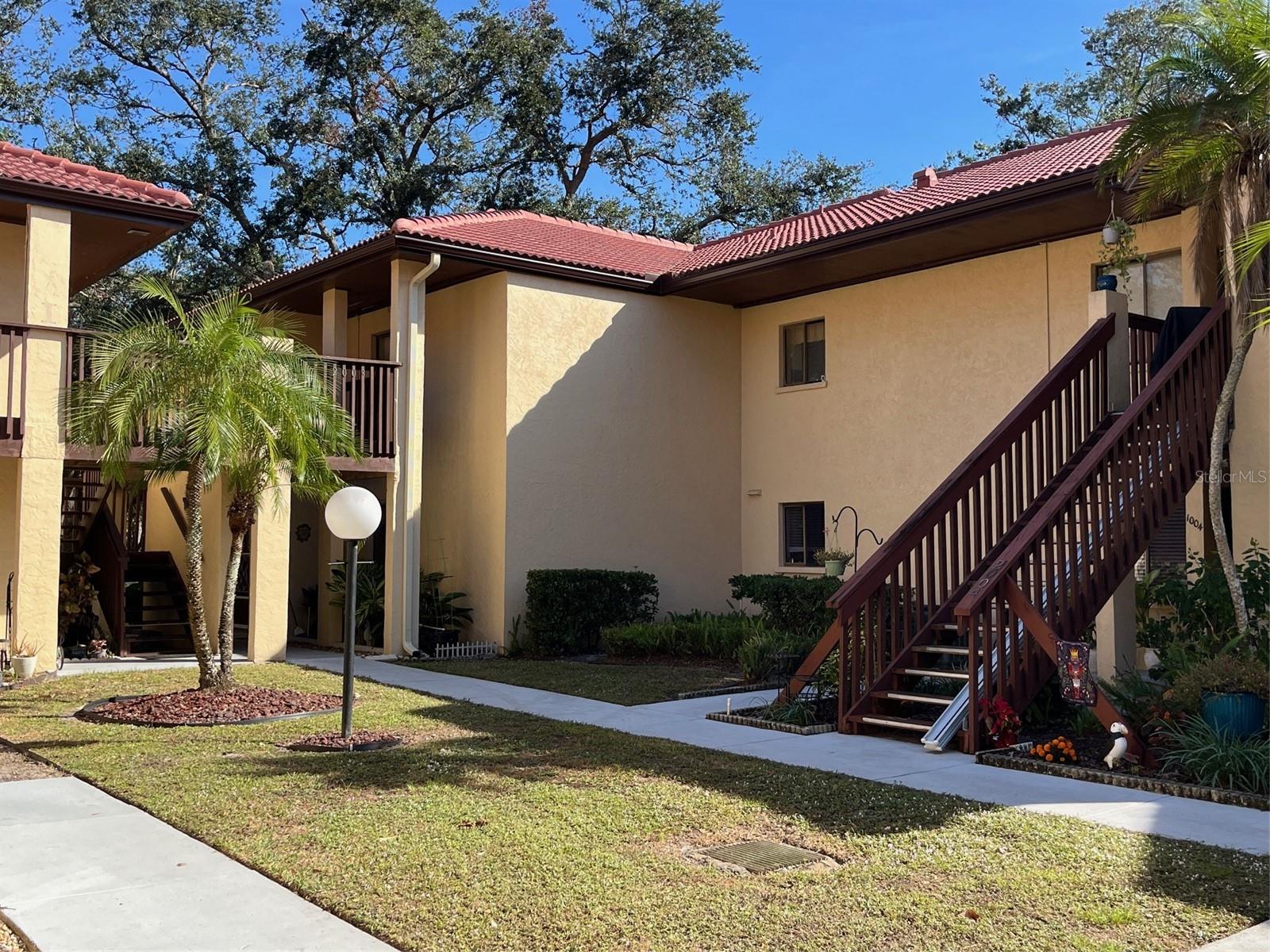Come enjoy the peace and beauty of the country lifestyle and still be a short ride to the city. Meticulously maintained, furnished, spacious 2 bedroom, 2 bath condo is in move-in condition. This end unit offers an abundance of natural light from every room. Tranquility and relaxation await you from the screen enclosed back lanai overlooking a beautiful parklike setting where you can see nature or an occasional deer. Exquisitely landscaped and maintained courtyard setting. Maintenance free living at its best. Spacious rooms throughout. A/C replaced 2022, dryer 2023, newer stainless-steel appliances, luxury vinyl flooring throughout other than carpeting in bedrooms. Kitchen and wet areas have ceramic tile. New roofs in complex were replaced May 2024, newly painted buildings, new decks to be replaced 2025. Condo amenities include heated community pool, tennis courts, shuffleboard, water access to Manatee River where you can enjoy canoeing or kayaking on the river or relaxing fishing and viewing an occasional Manatee swimming by. Monthly association fee of $450 includes water,sewer,trash pickup, pest control, exterior and ground maintenance, internet and Spectrum TV. 55+ community. 2nd floor end unit.